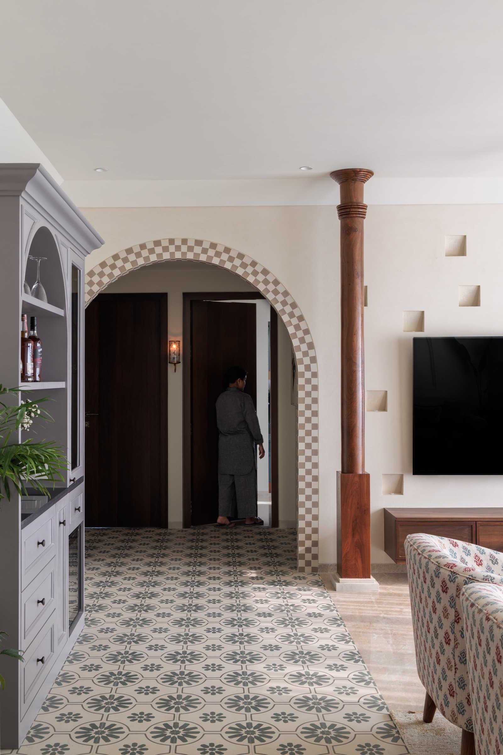 Checkered arch, timber column, and patterned tile: the spatial logic of the home's threshold between public and private zones