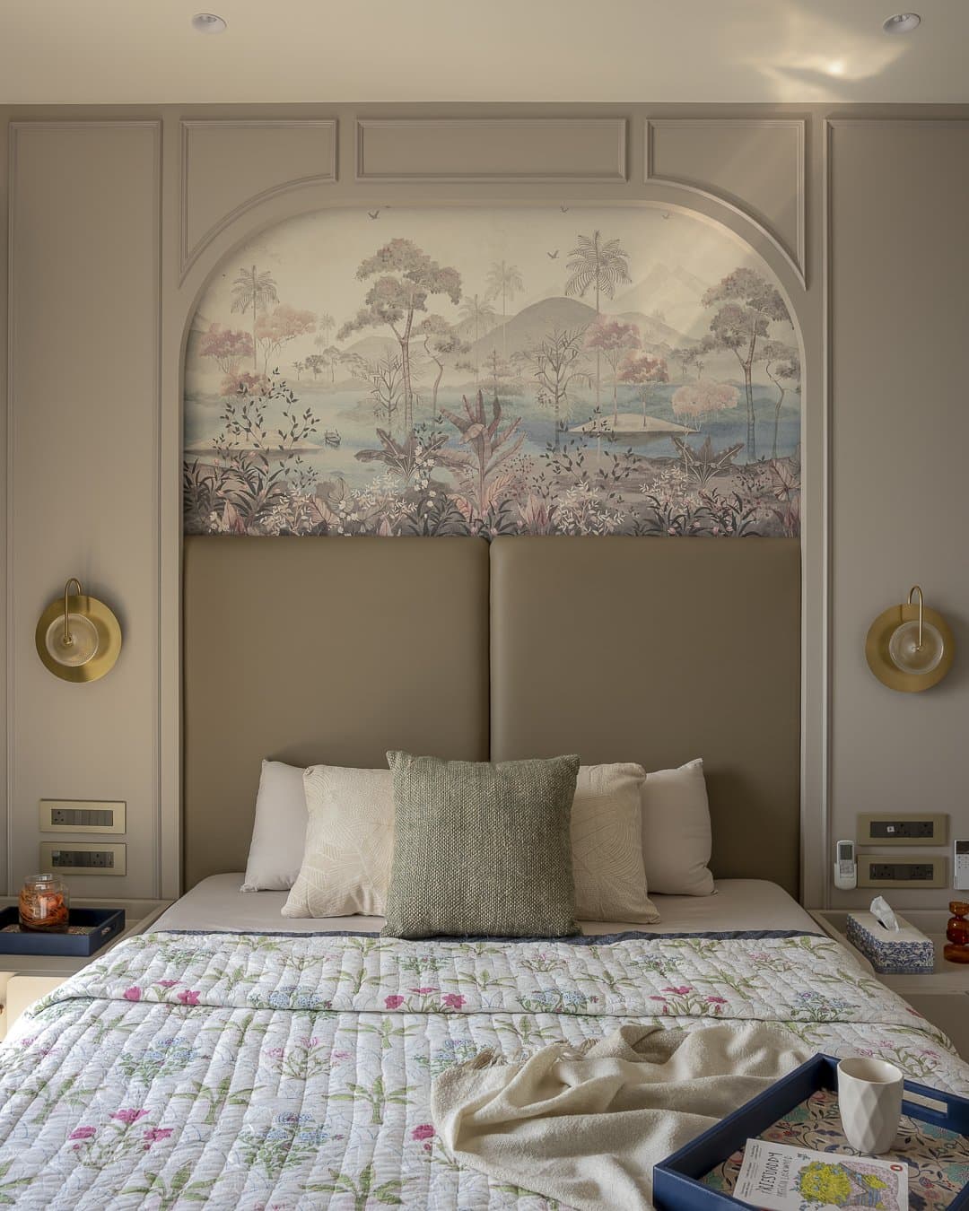 The master bedroom's arched headboard wall, where a hand-painted tropical mural brings narrative colour to the home's most private room
