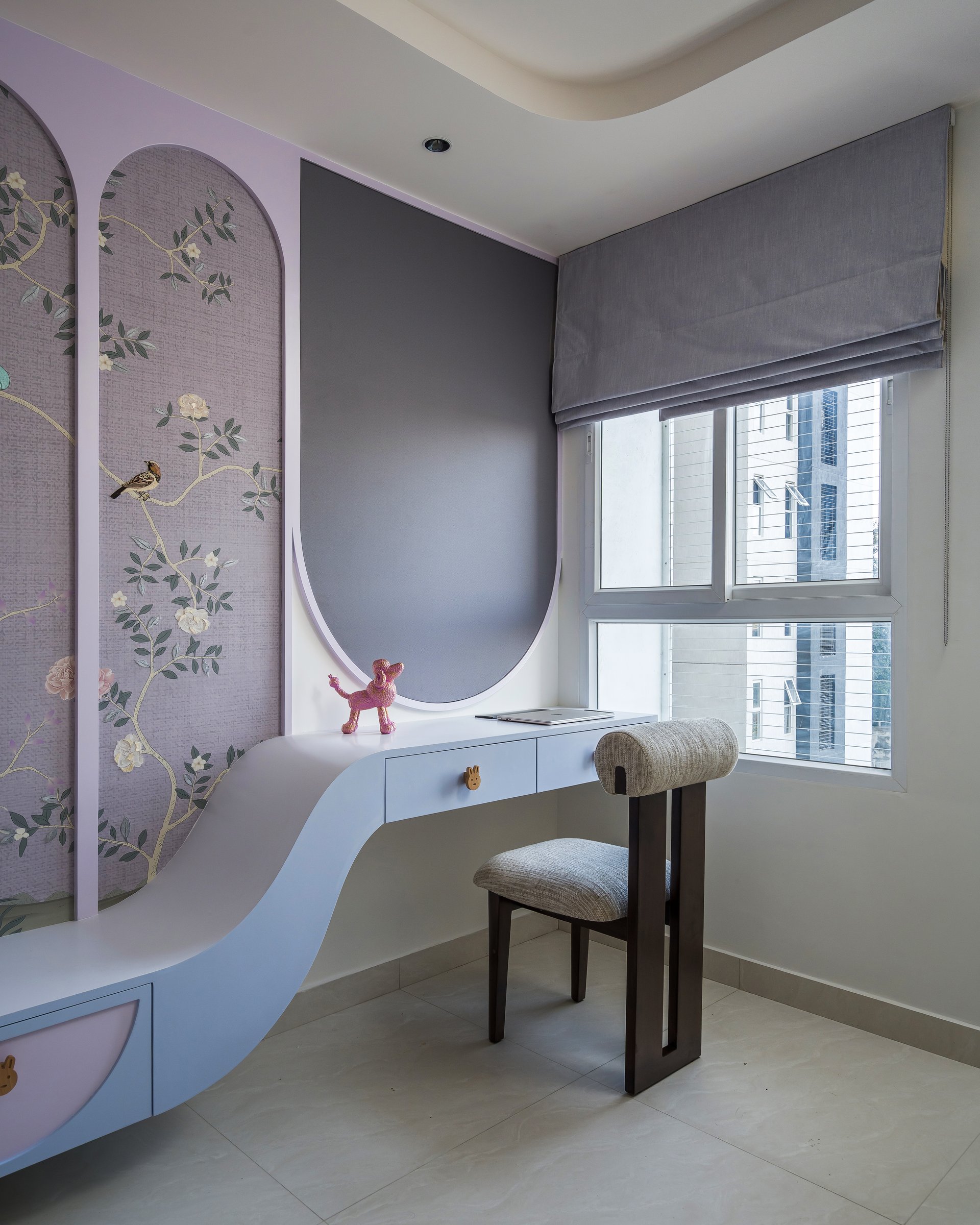 The study corner, where a single unbroken curve connects storage to desk surface