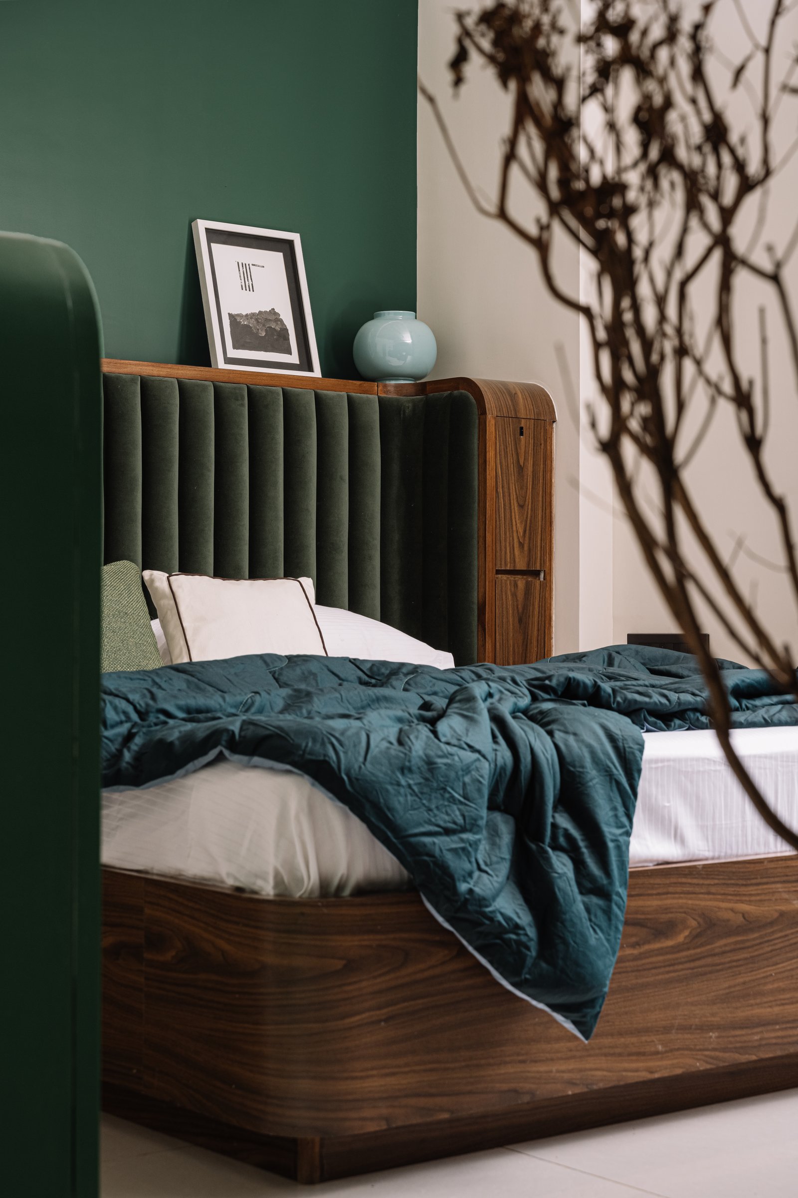 The daughter's bedroom in saturated forest green, velvet and dark walnut establishing a distinct identity
