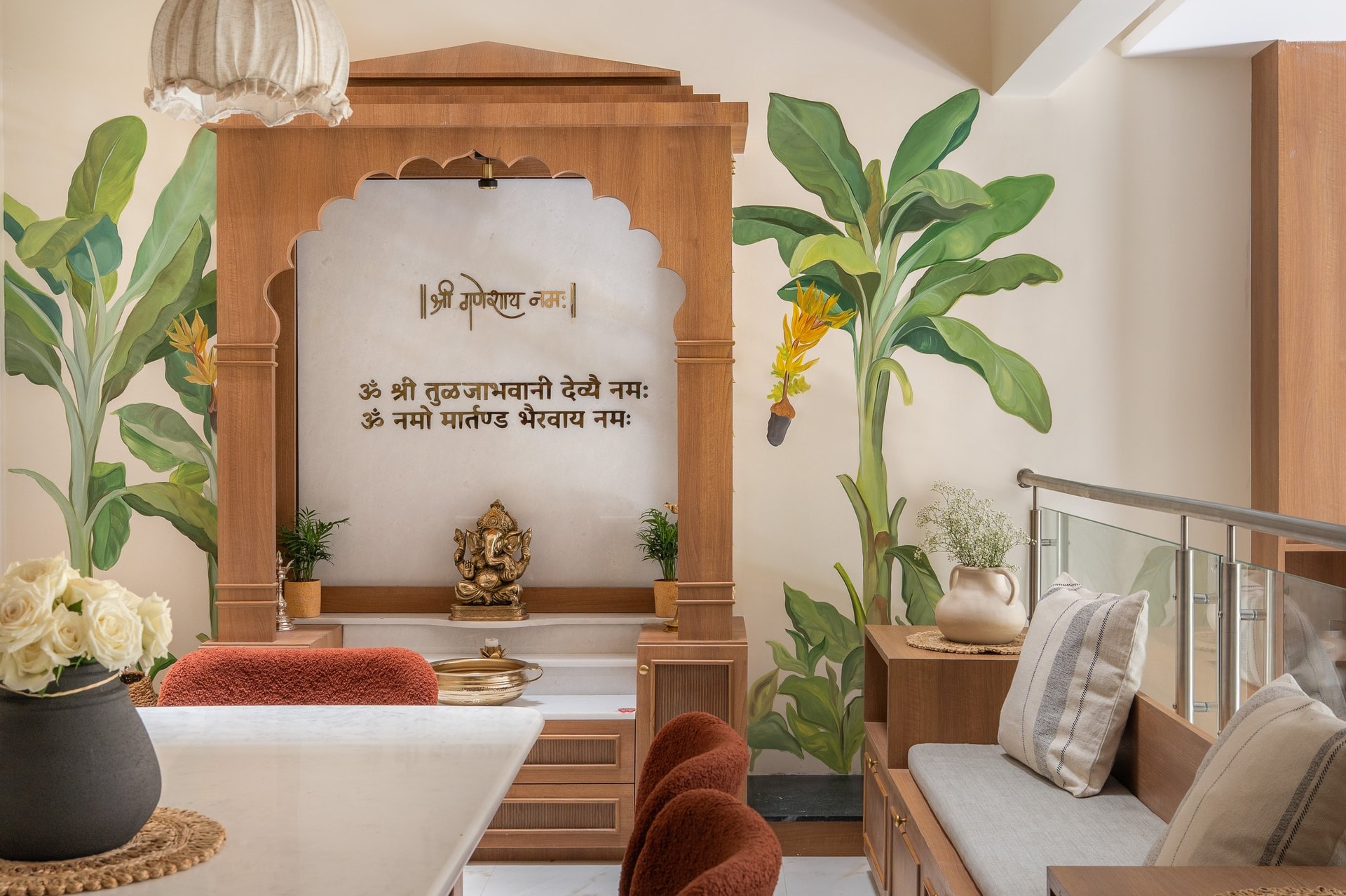 The family's puja space, framed by hand-painted banana leaves