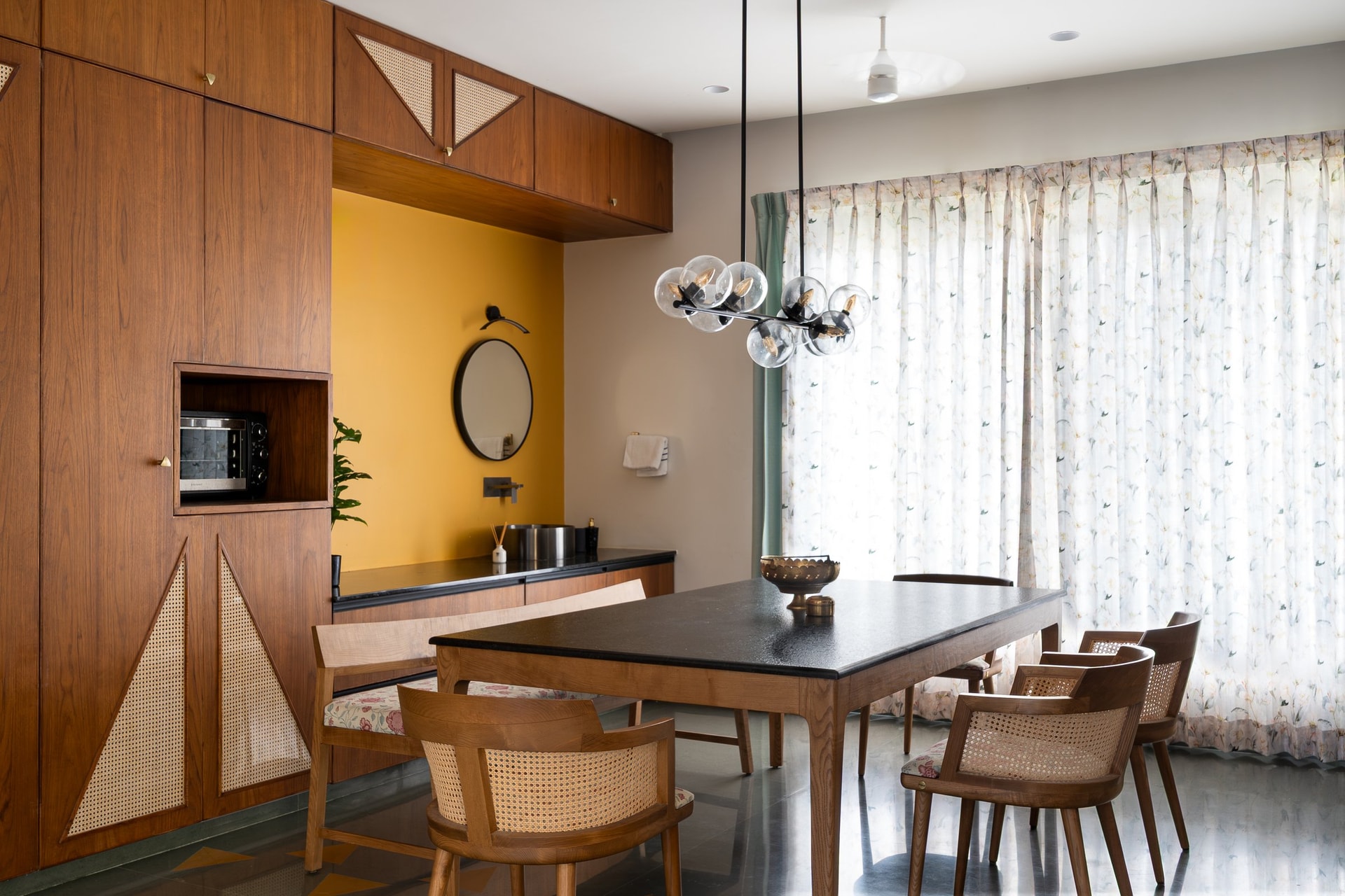 The dining area, where a floor-to-ceiling timber-and-cane joinery wall anchors the space