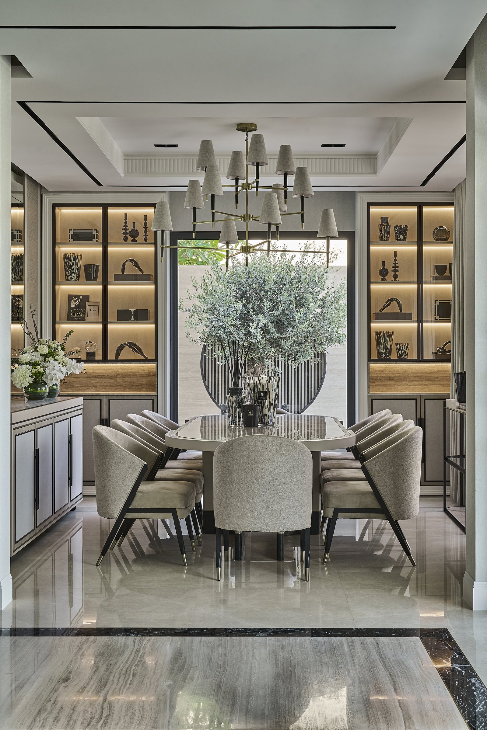 The dining room, presided over by a second olive and flanked by backlit display cabinets