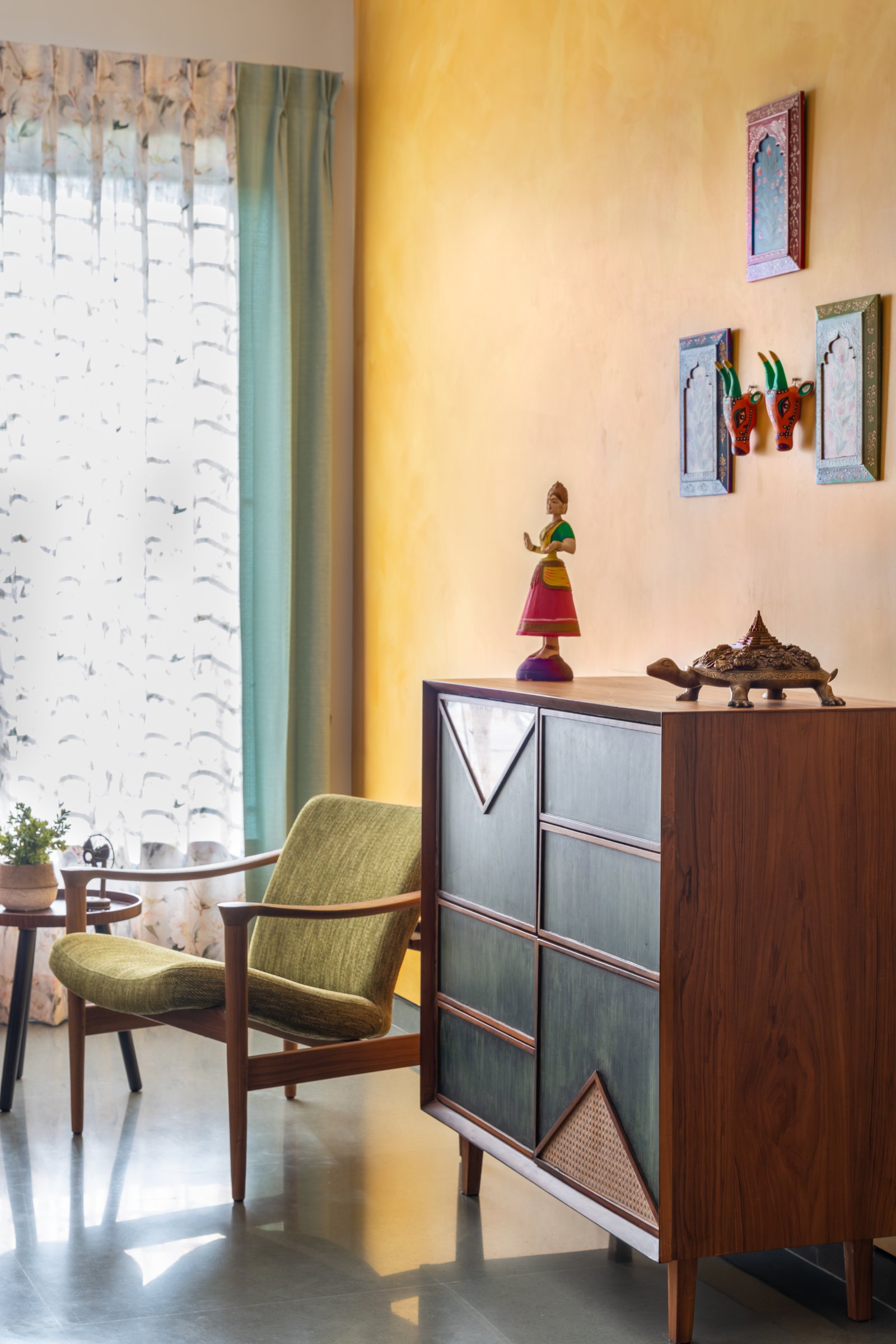 The foyer, where an ochre-washed wall and a handcrafted console with cane inlay set the home's tonal register