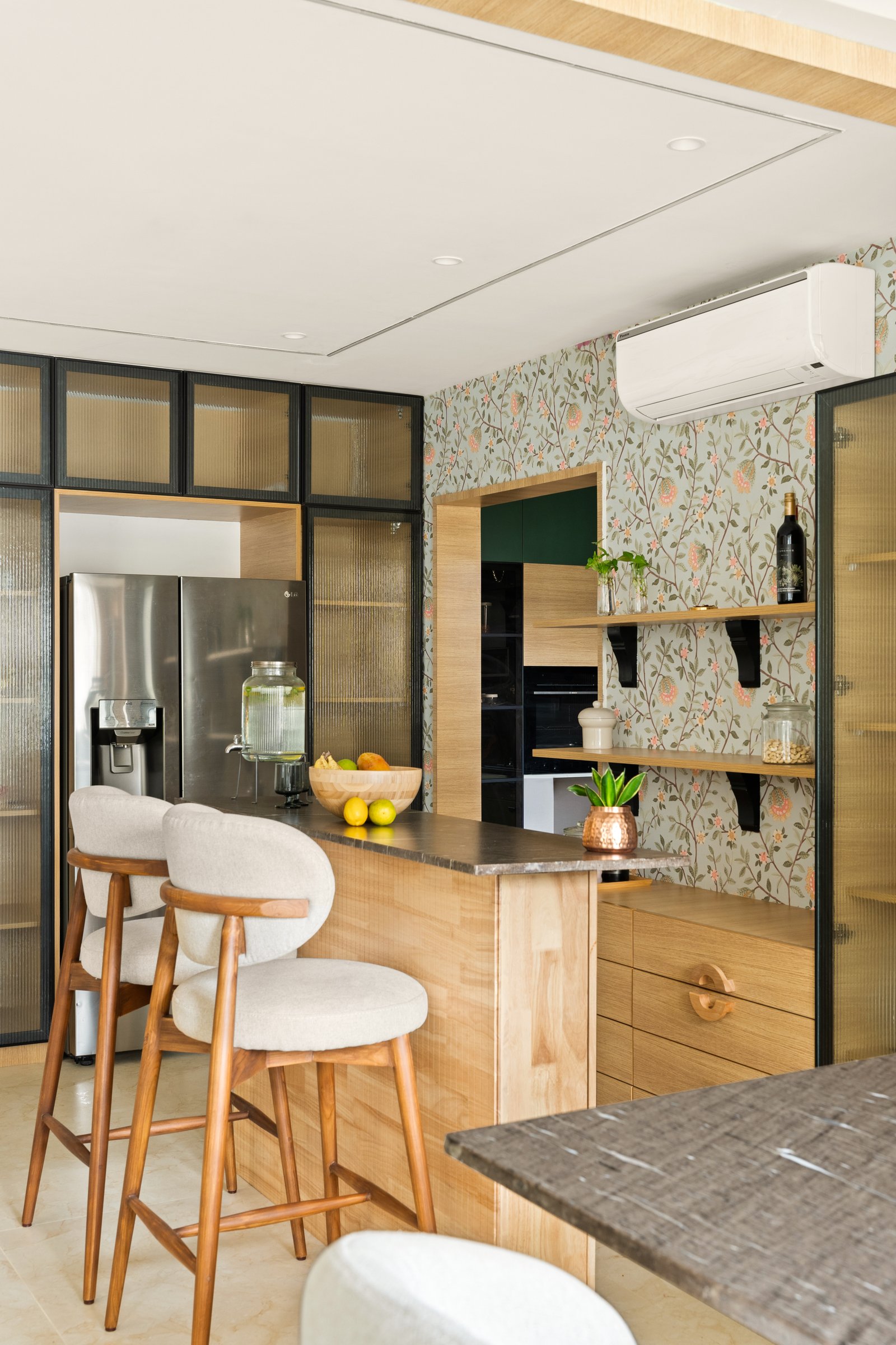 The kitchen island seen from the dining side, where storage is layered rather than hidden