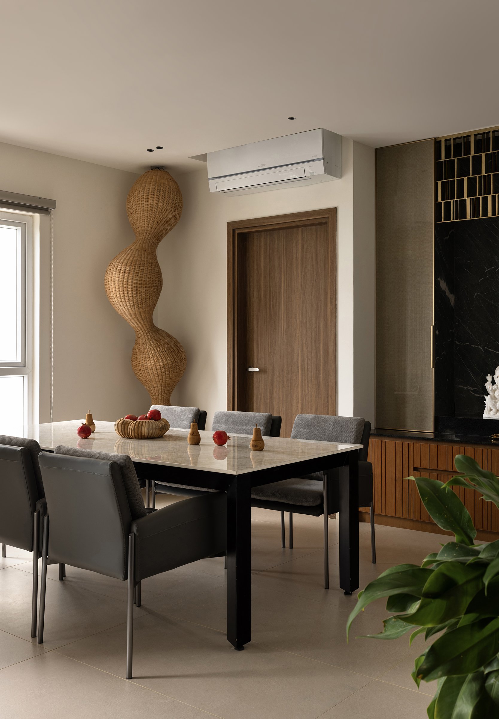 The dining area: an in-house parametric cane installation, built with local artisans, anchors the room as sculpture