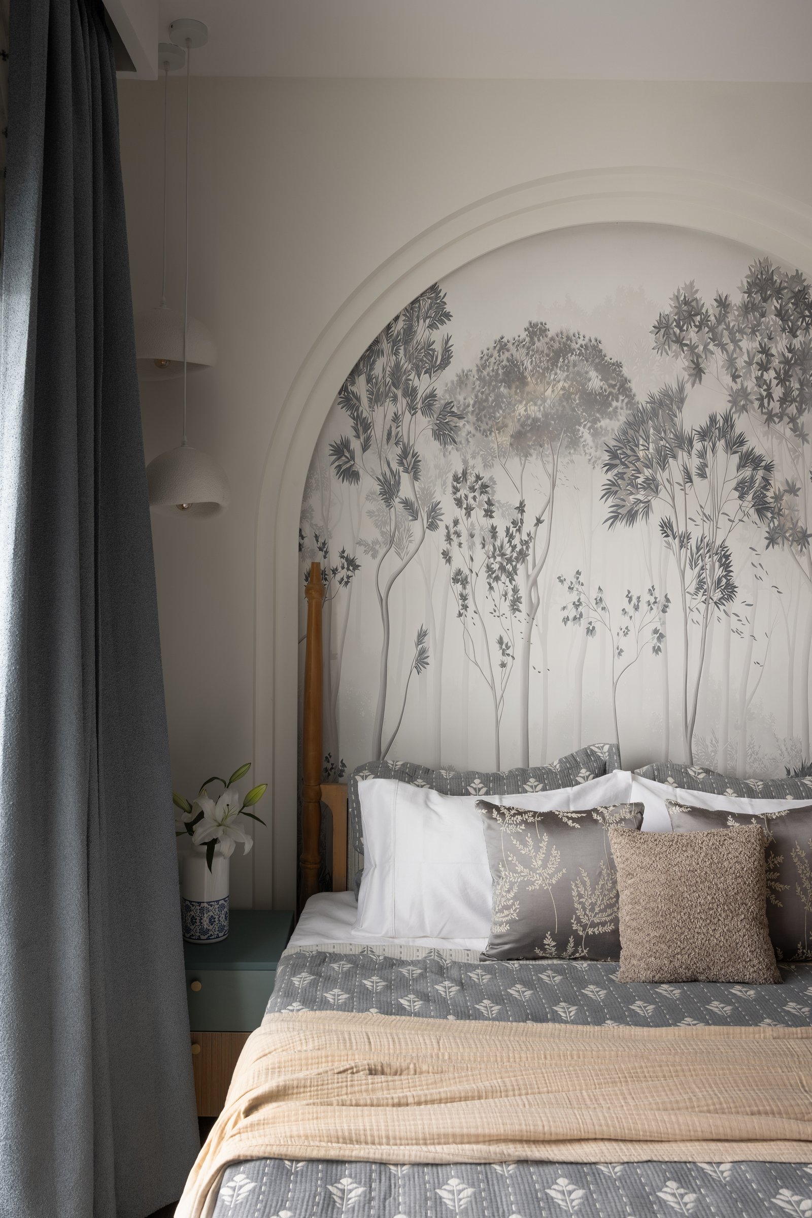 Seen from the side, the arched recess gives the mural the quality of a painted alcove rather than a feature wall