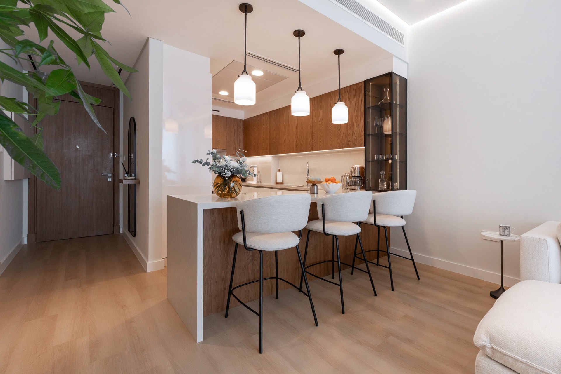 The peninsula projects into the living space like a piece of furniture, not a service counter