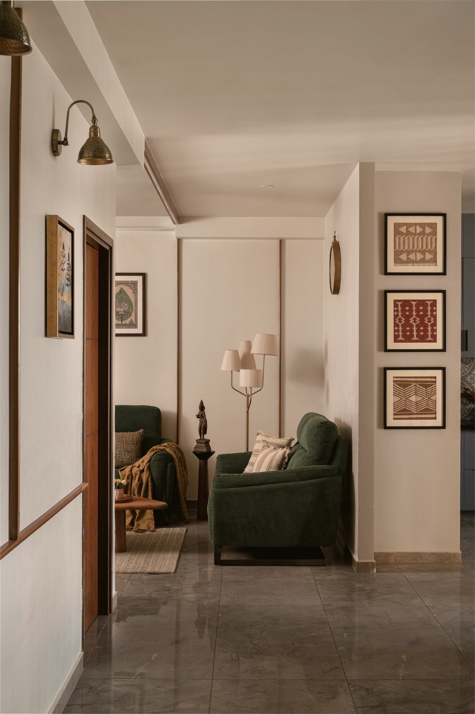 The threshold between foyer and living area, where a triptych of woven-textile works sets the home's pattern vocabulary