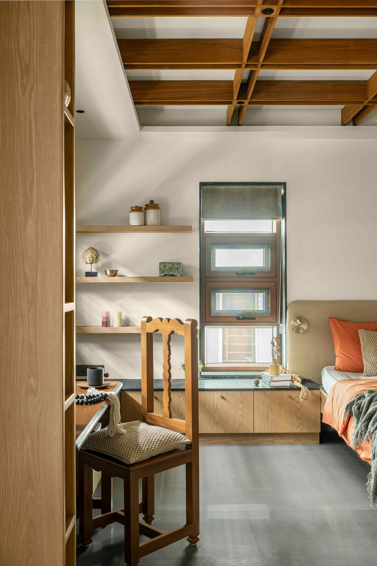 A built-in study nook with floating oak shelves and an inherited turned-wood chair finds new daily purpose