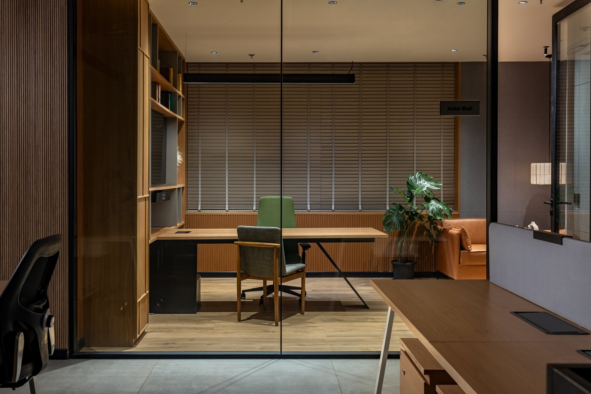A second cabin organised for sustained attention, with slatted blinds filtering the daylight