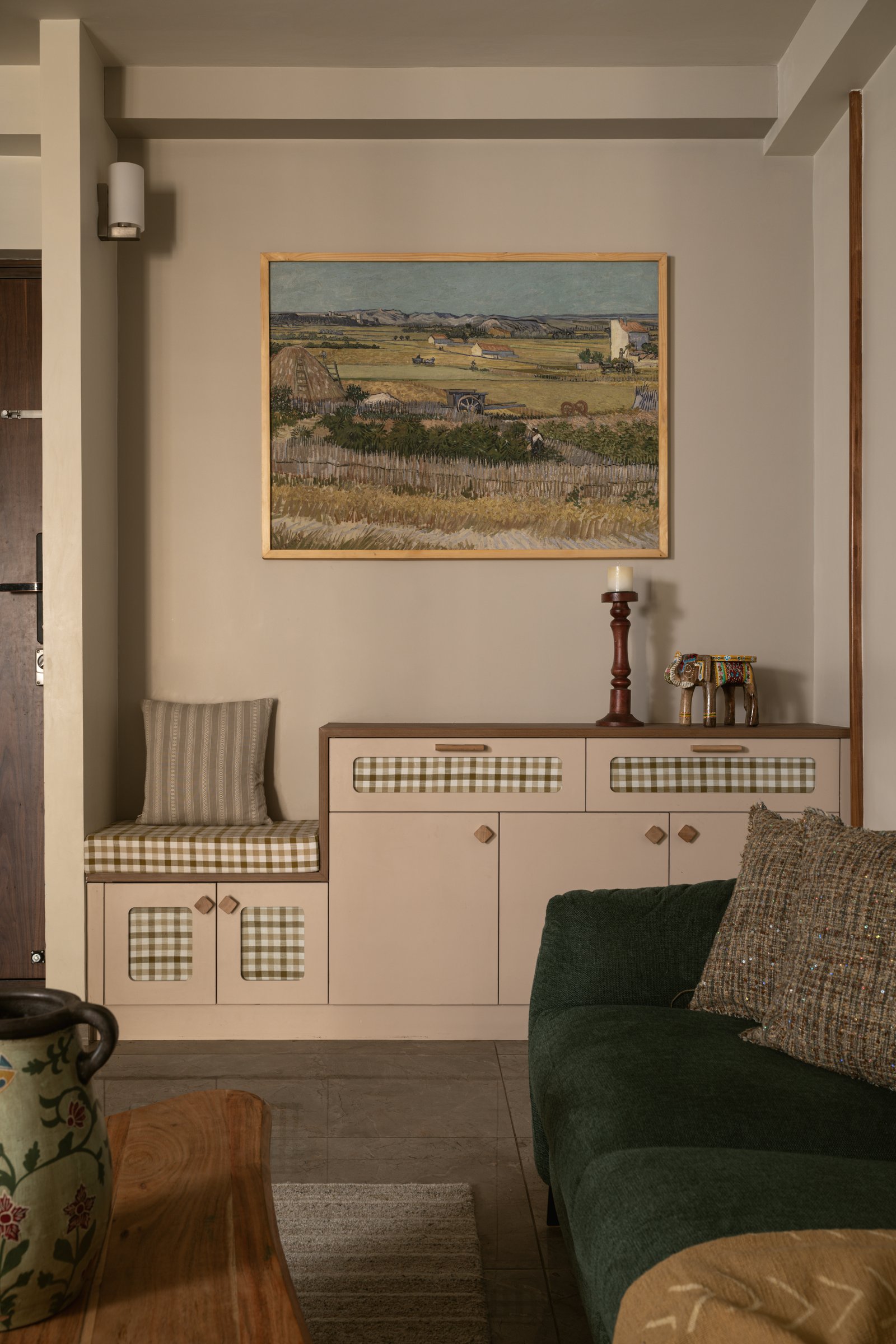 A built-in window seat folded into the storage line, gaining the apartment a place to pause without adding a square foot