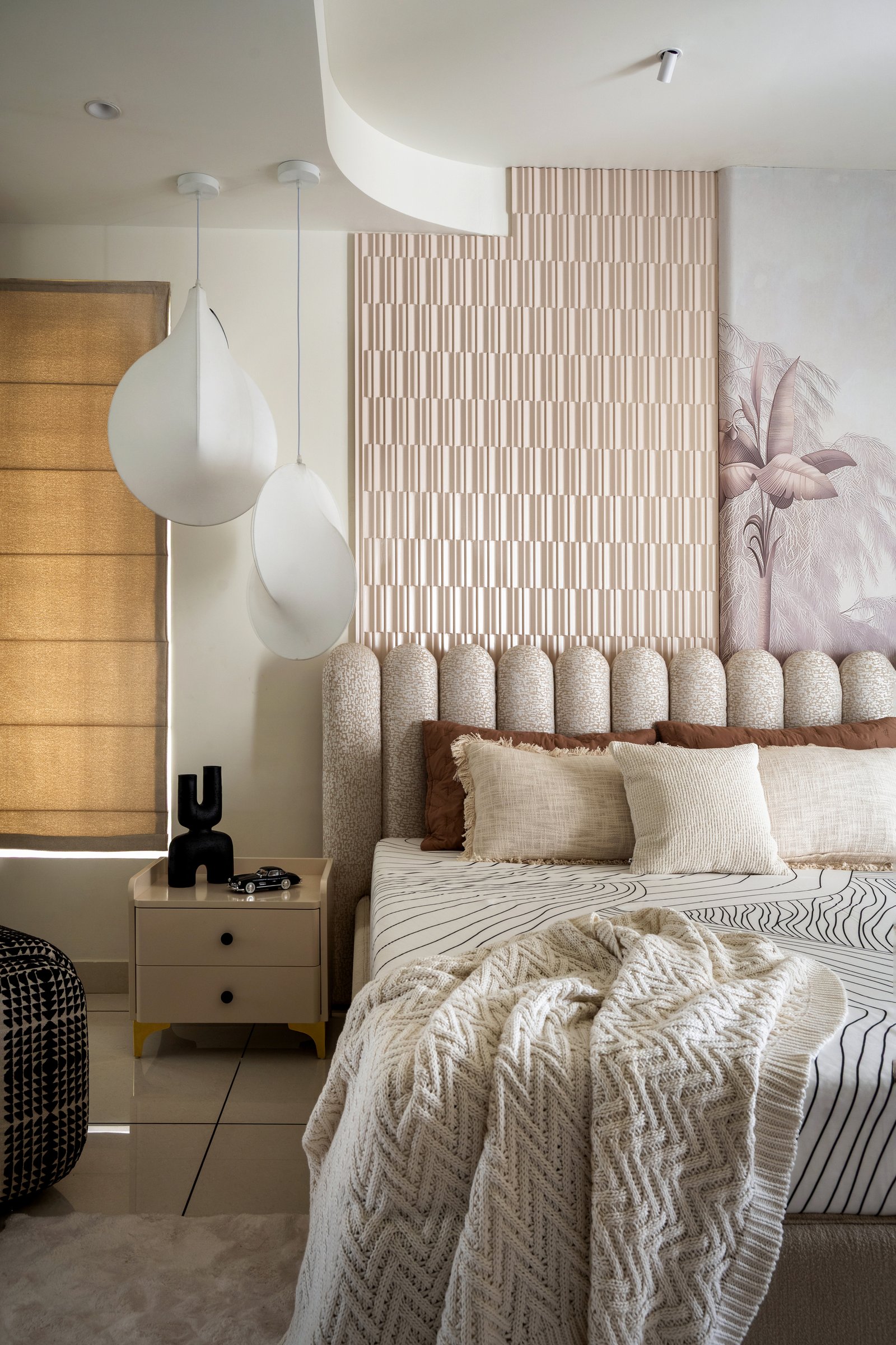 The children's bedroom: a scalloped upholstered headboard, fluted panel, and hand-painted botanical mural