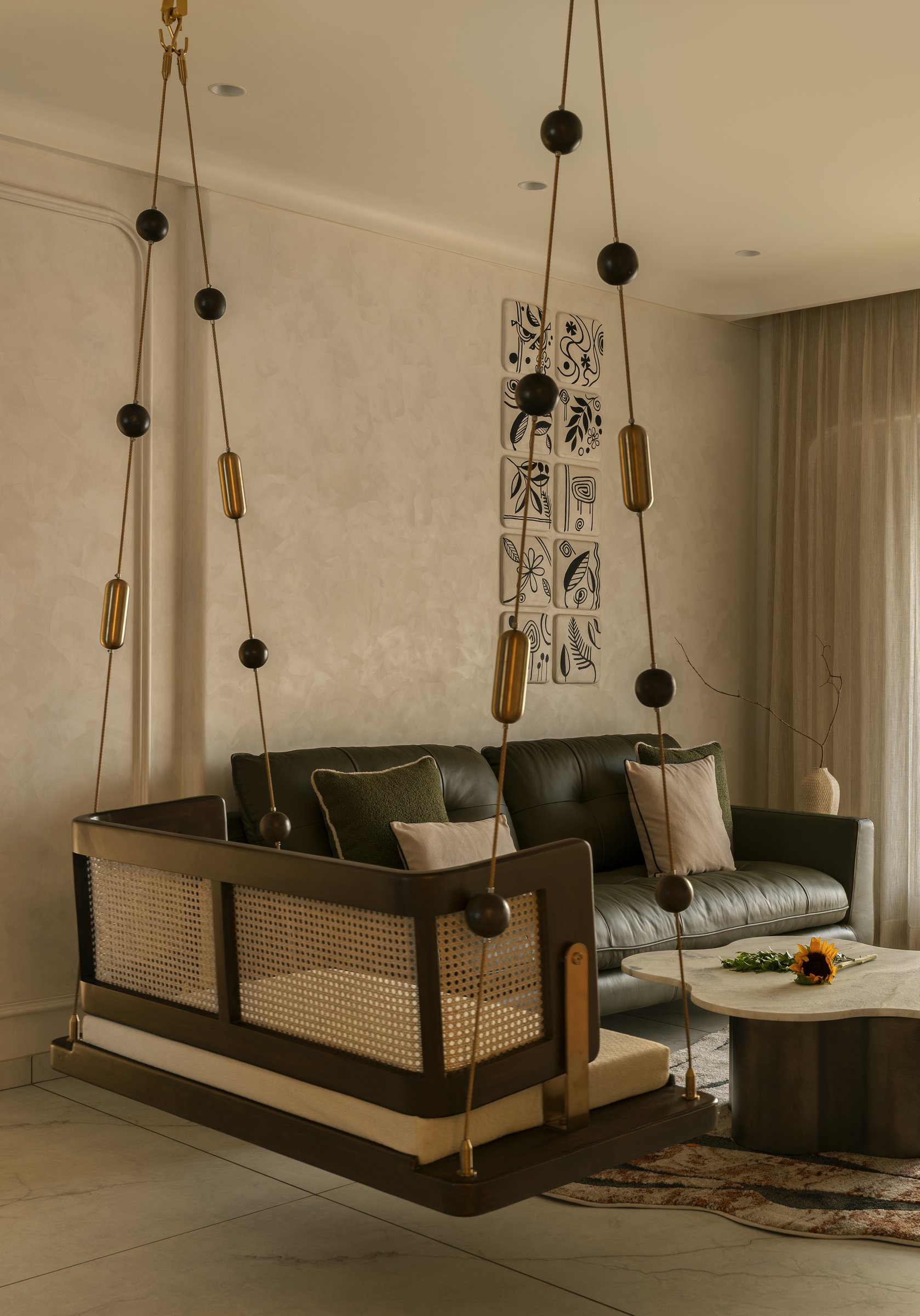 The cane-and-wood jhoola folds a deeply Indian object into a contemporary palette without nostalgia or self-consciousness