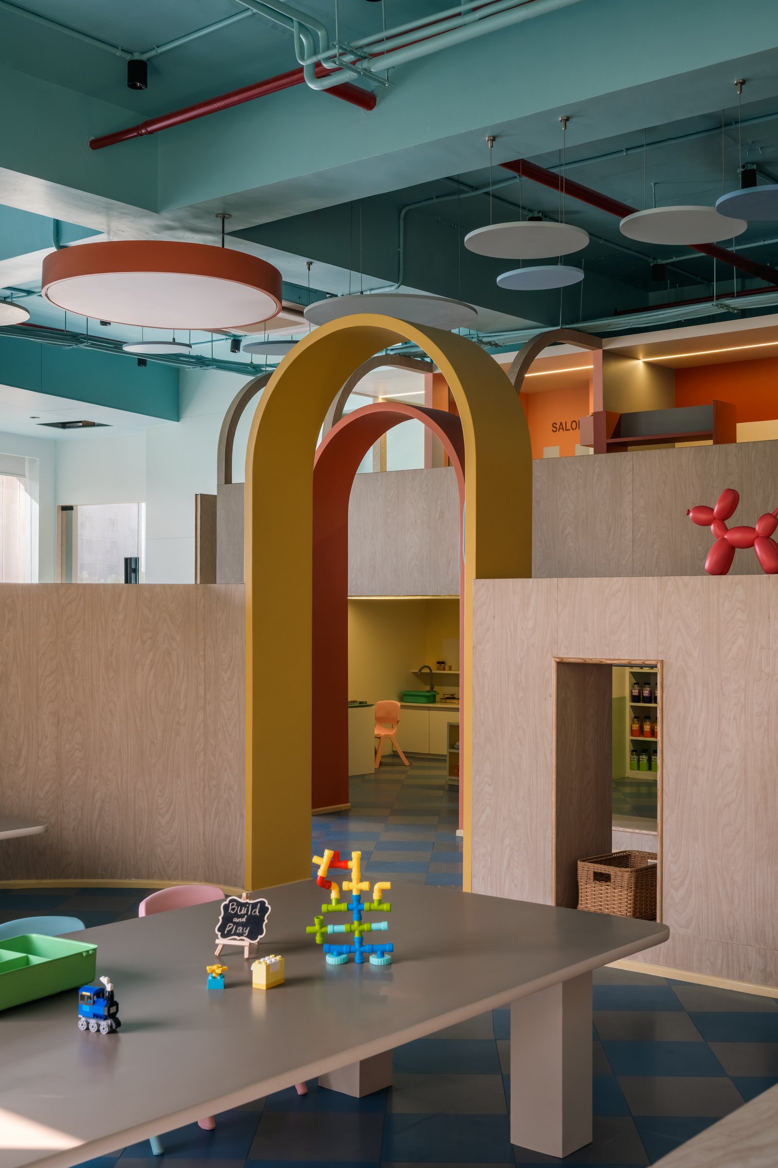 Inside Build and Construct, three nested arches frame views into the salon and beyond