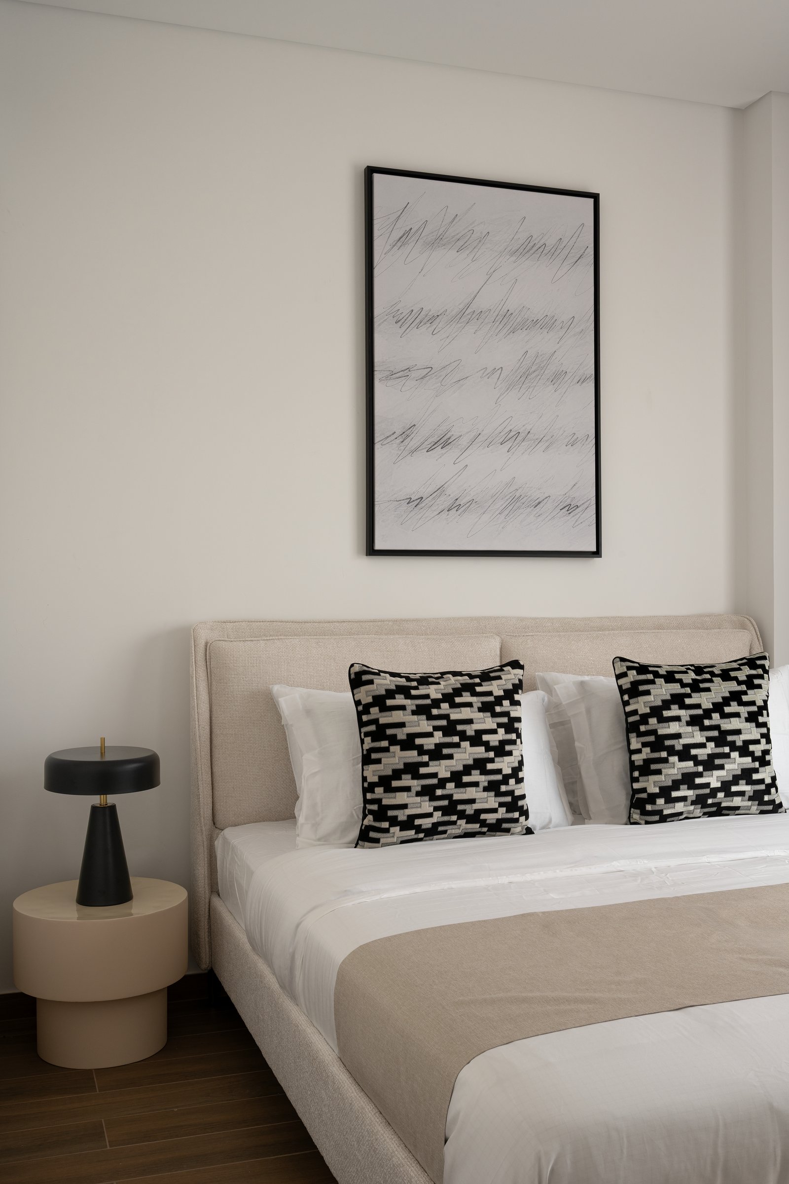 In the master bedroom, a gestural charcoal work brings kinetic energy to an otherwise still composition