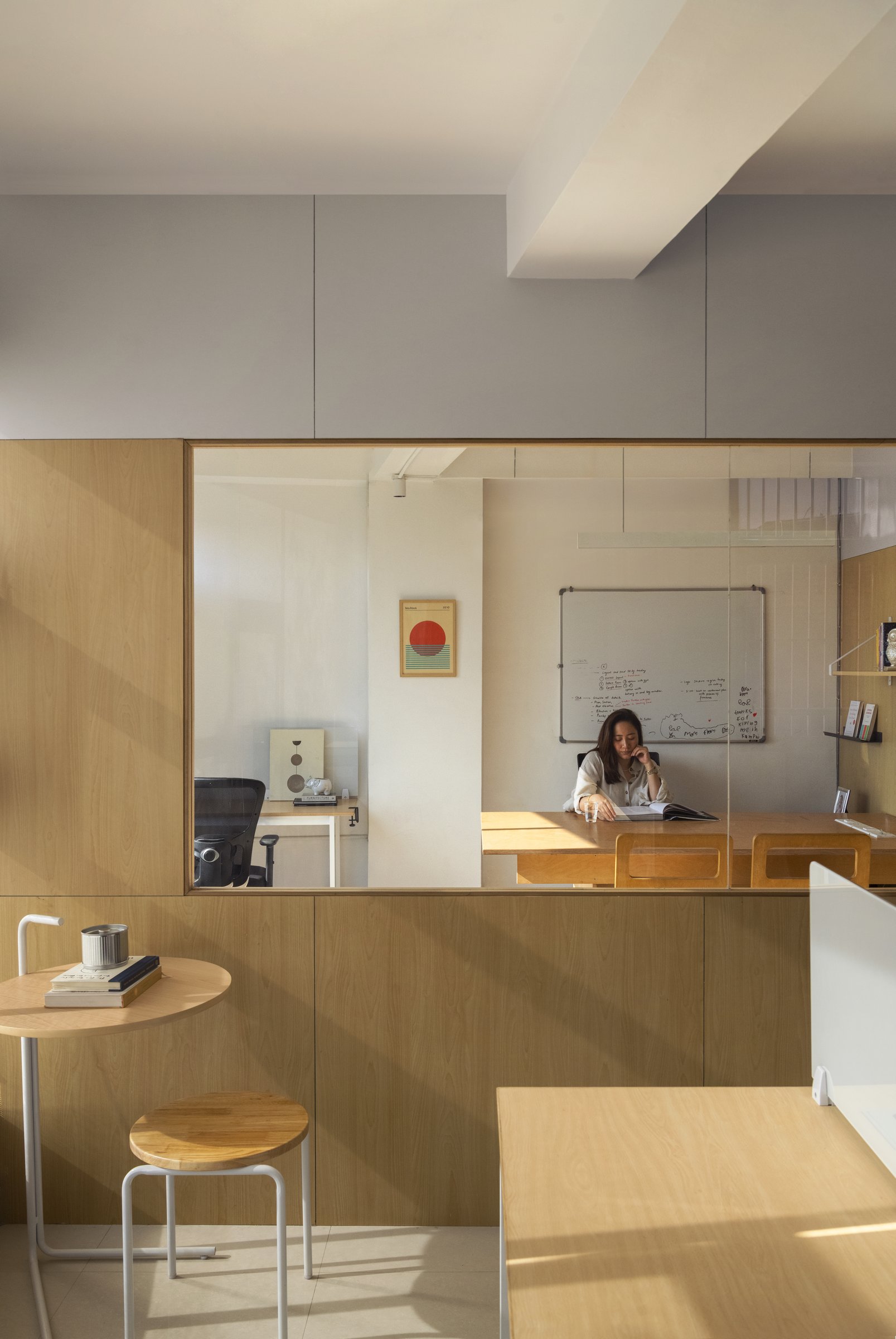 An internal window between the founder's cabin and the corridor: privacy as a partial, generous thing
