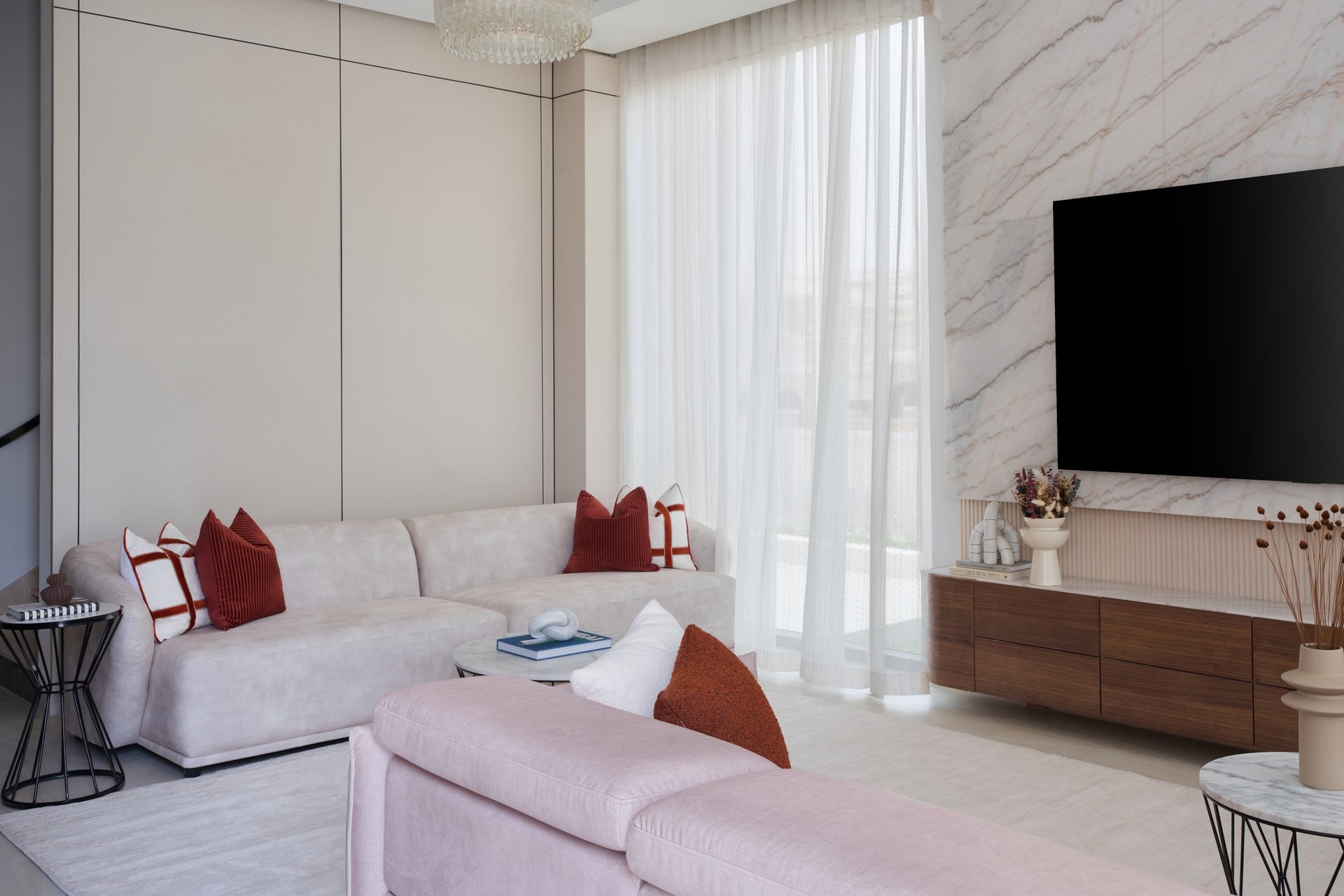 Two sofas in tonal variations of the same palette acknowledge that the room hosts more than one social mode