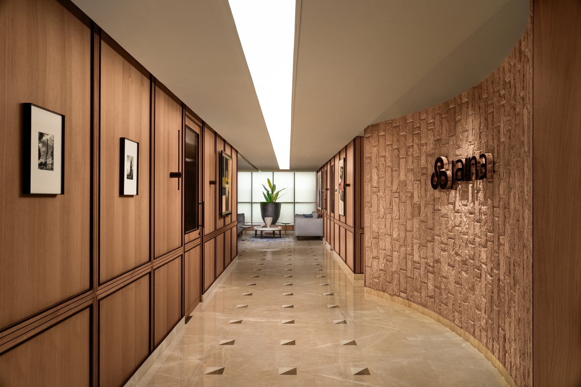The central spine, where panelled wood meets the textured stone of the reception curve
