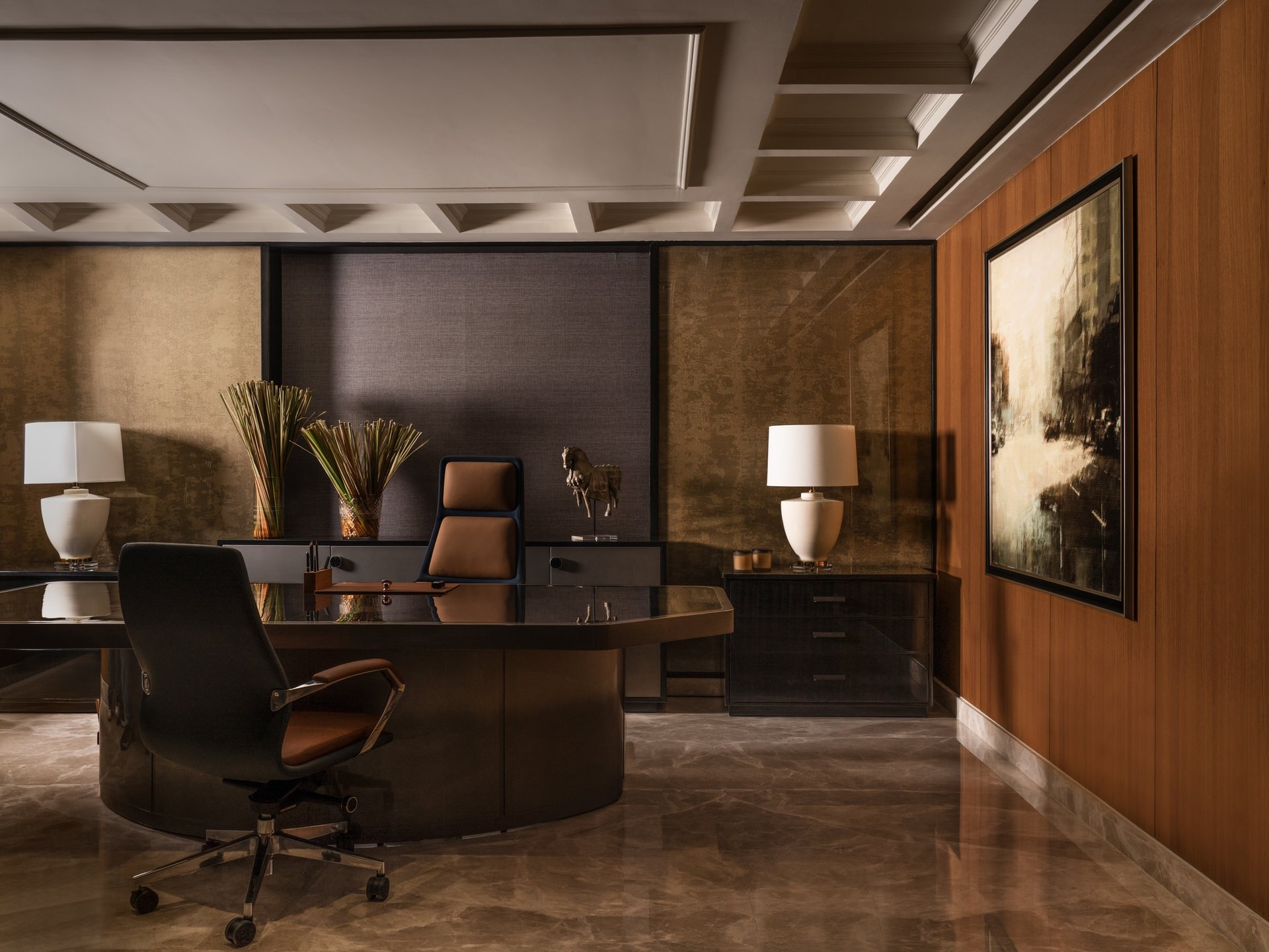 The principal's cabin, with aged gold-leaf wall panels and a curved dark-veneer desk
