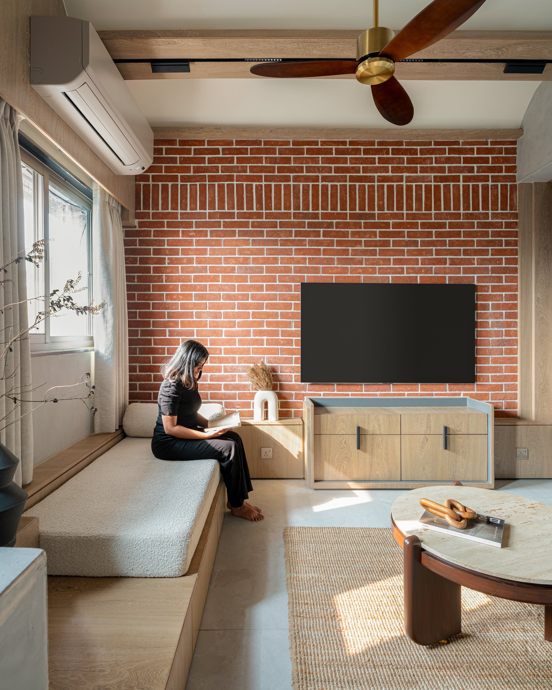 The brick wall earns its place because nothing else in the room competes for it