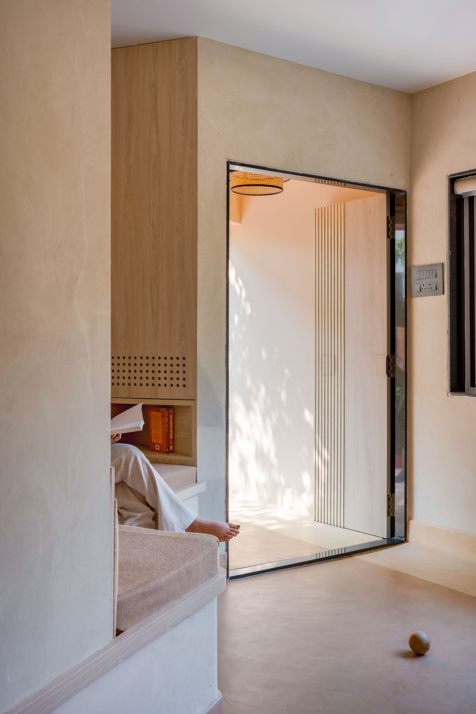 The waiting space, carved from the former kitchen, where a built-in ledge reads more domestic than commercial