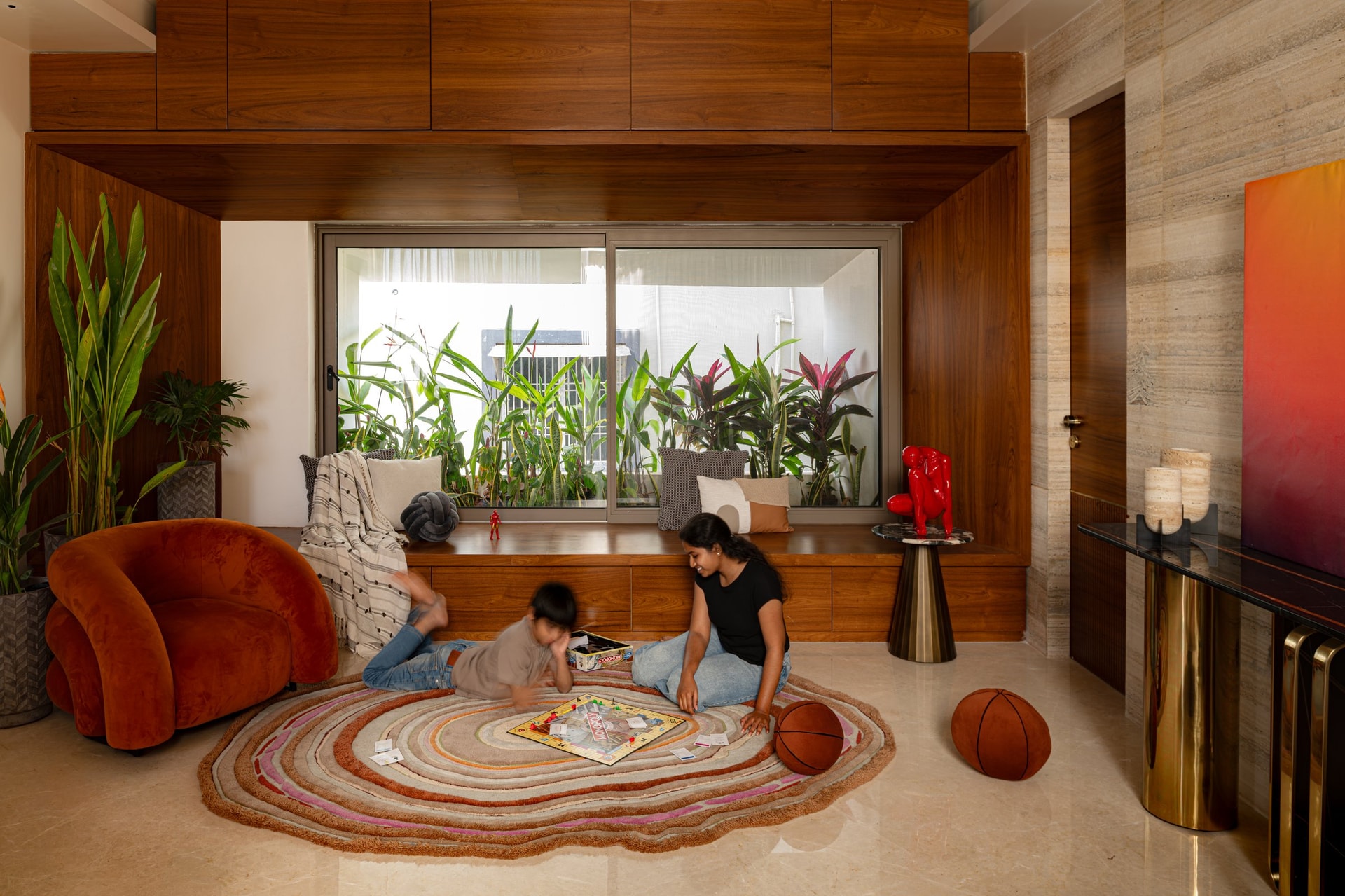 A window seat off the lobby, opening onto a planted utility court that turns a service edge into a visual amenity