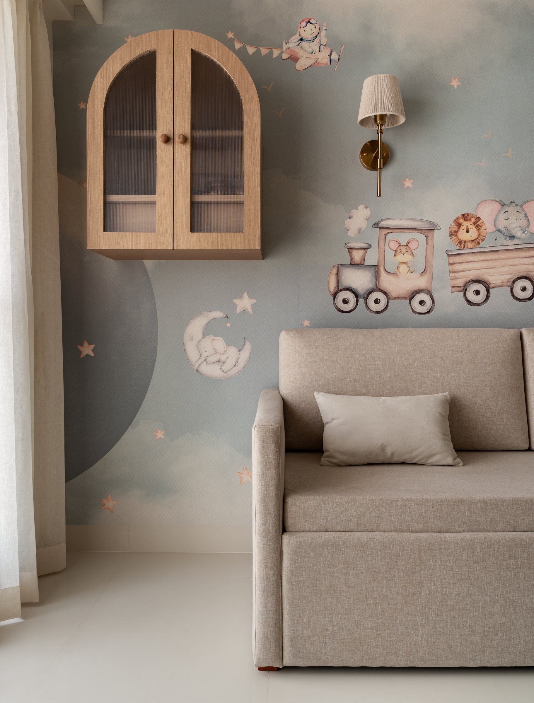 The children's room, where a watercolour mural of clouds and a small painted train extends the home's quiet register