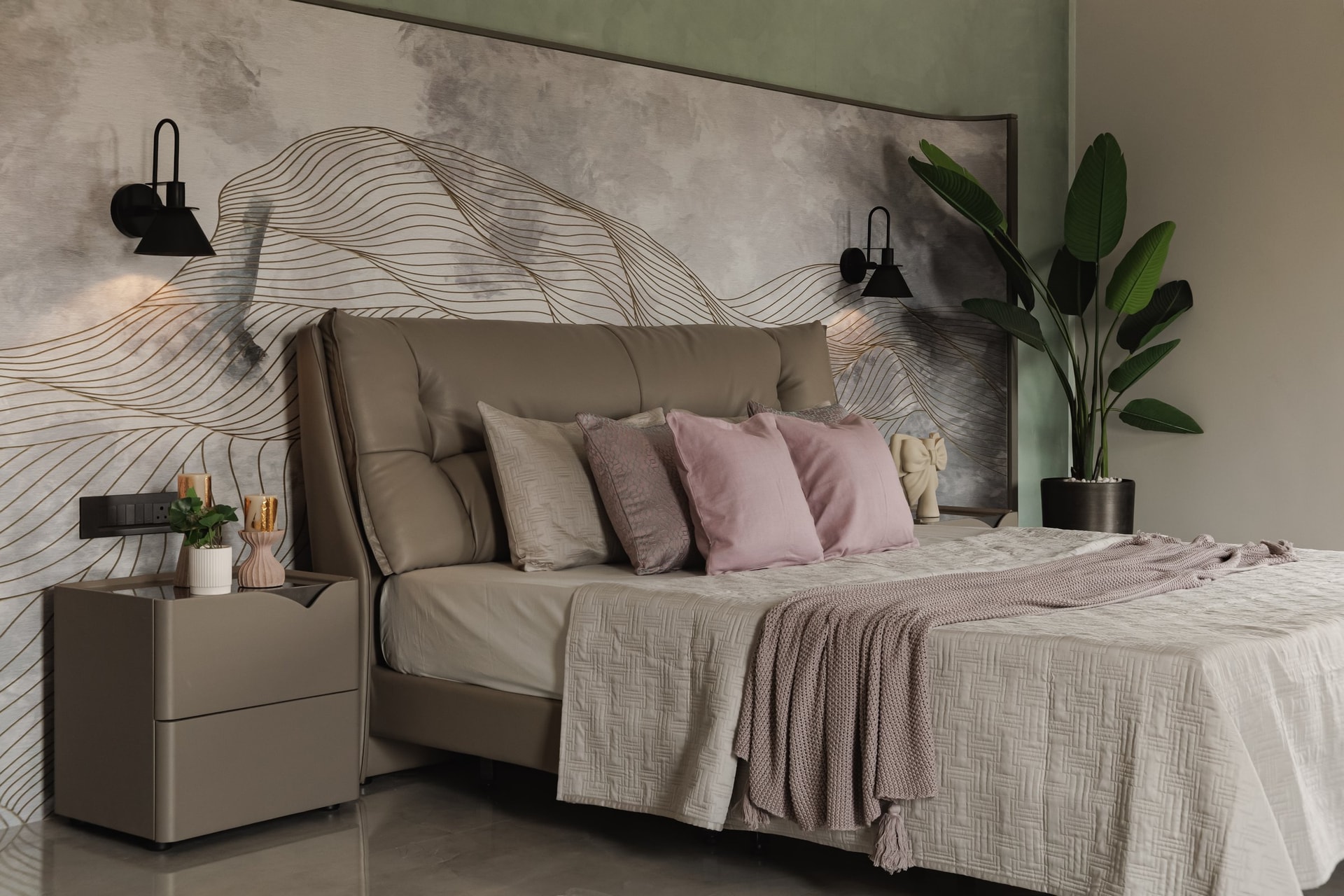 A second bedroom, where a painterly wallpaper in grey and gold turns the bed into the room's clear protagonist