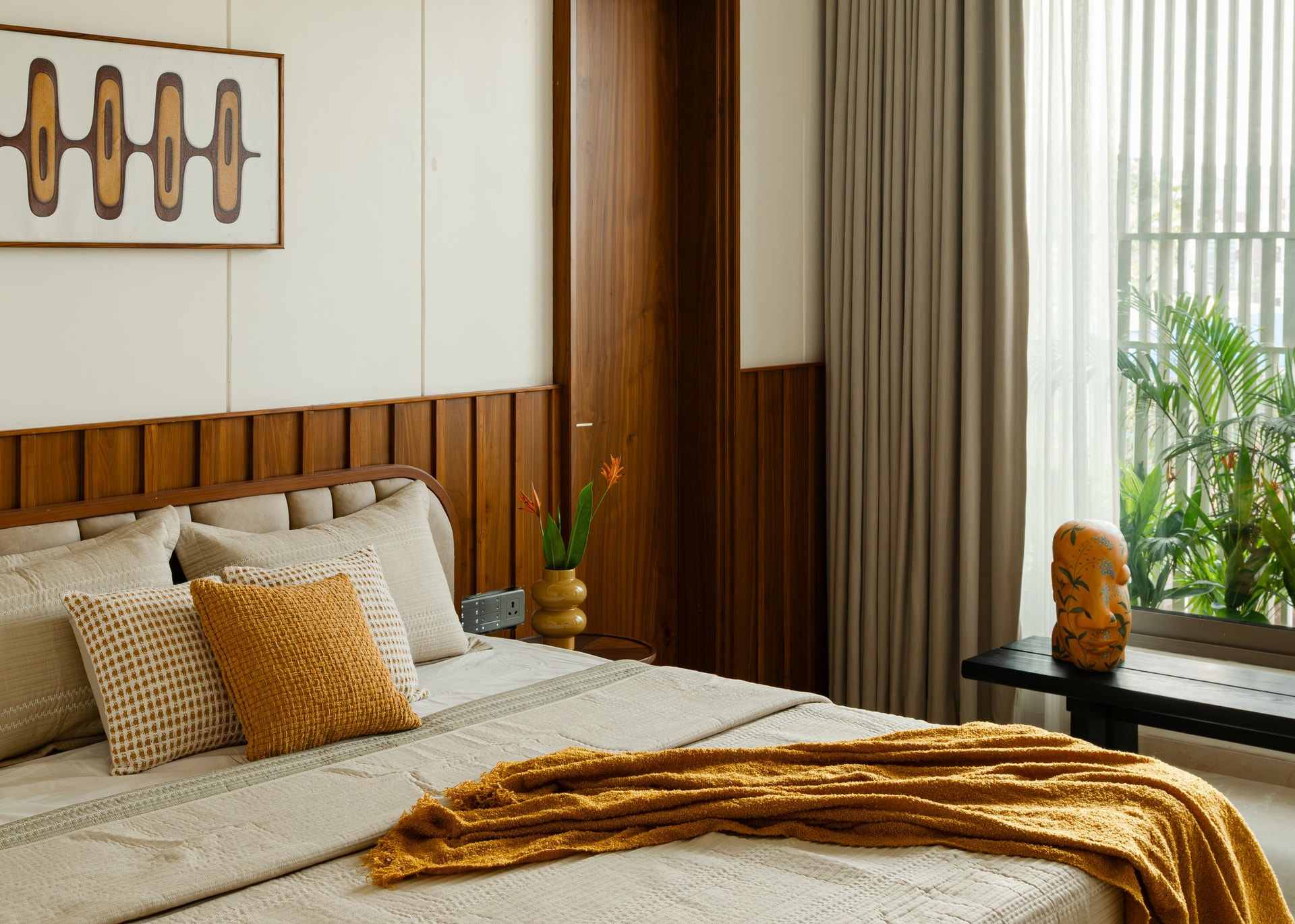 A closer view of the curved teak headboard and the slim panel concealing the wardrobe edge