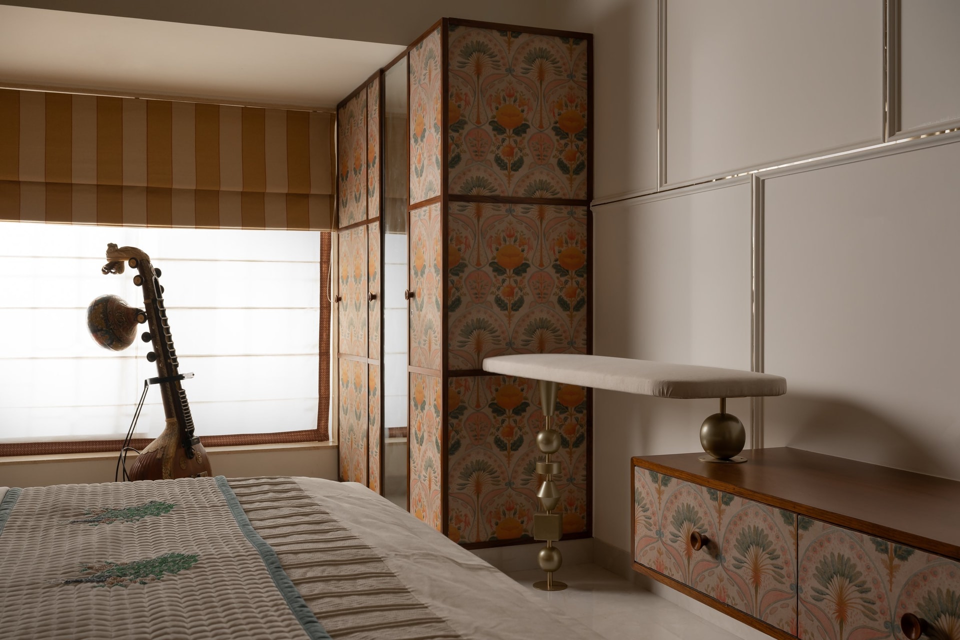 The dressing corner of the second bedroom, with a floated console echoing the wardrobe pattern