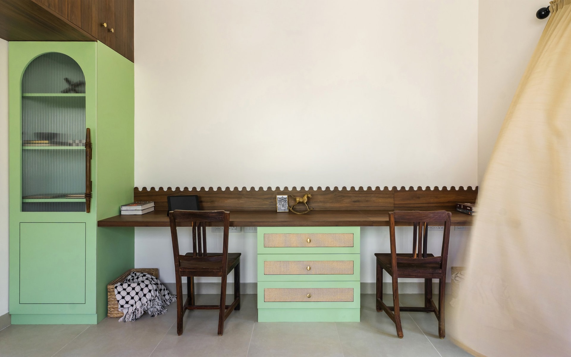 The second room's study, built in along one wall in soft mint with a wood desktop and scalloped backsplash