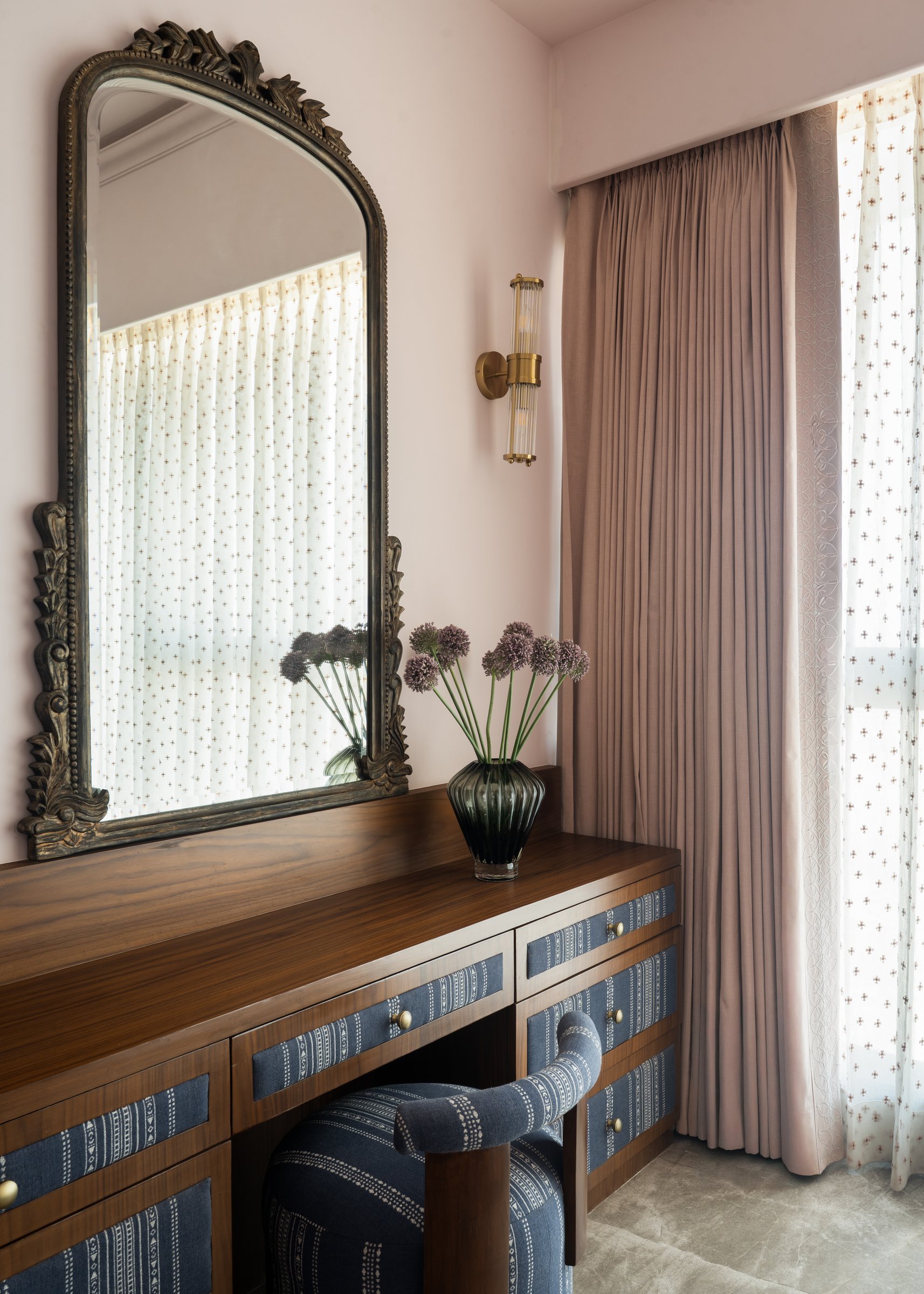 The master dressing area, with a carved mirror above an indigo-fronted vanity