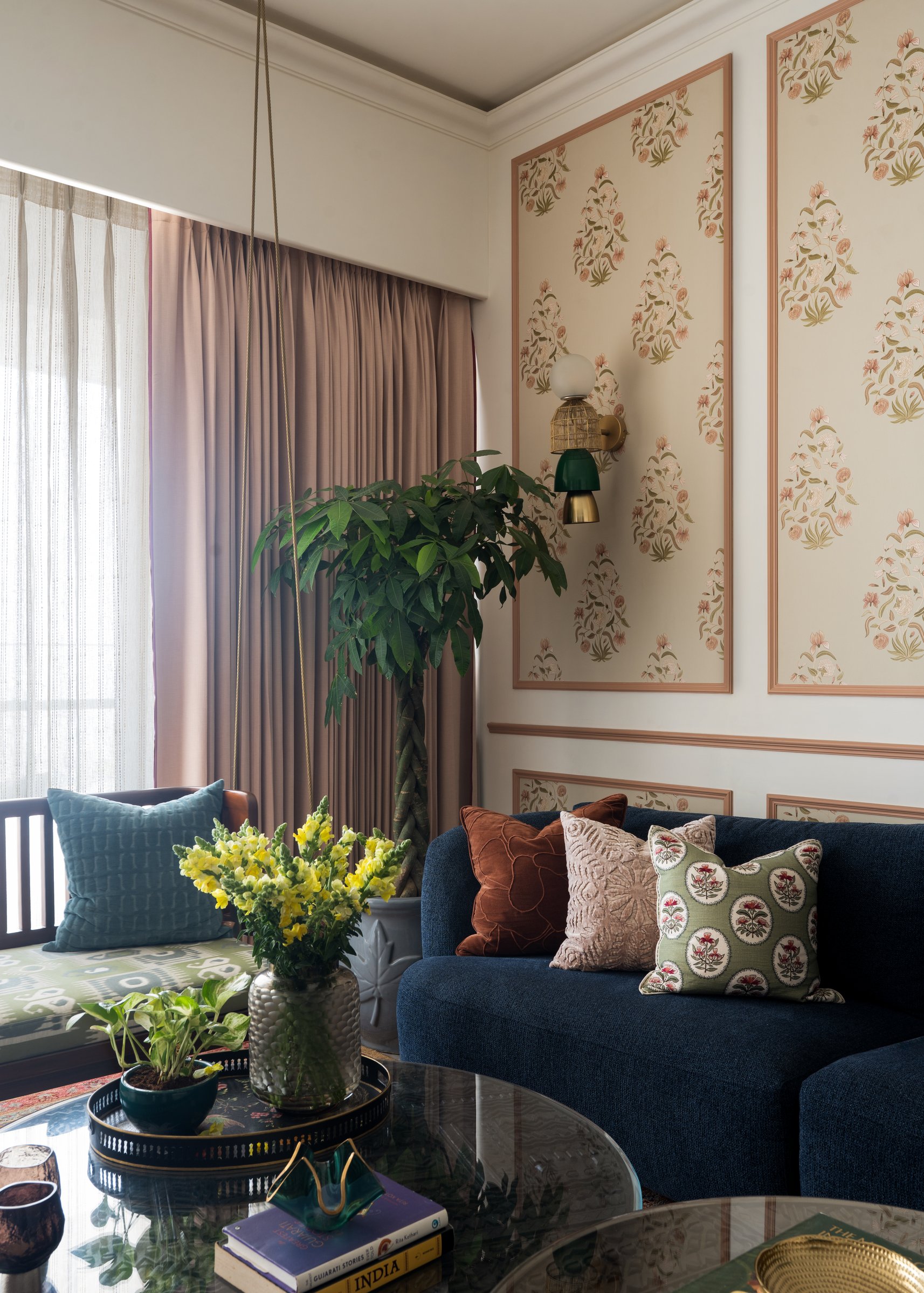 A closer view of the living room's cushion arrangement, layered across velvet, embroidery and block print
