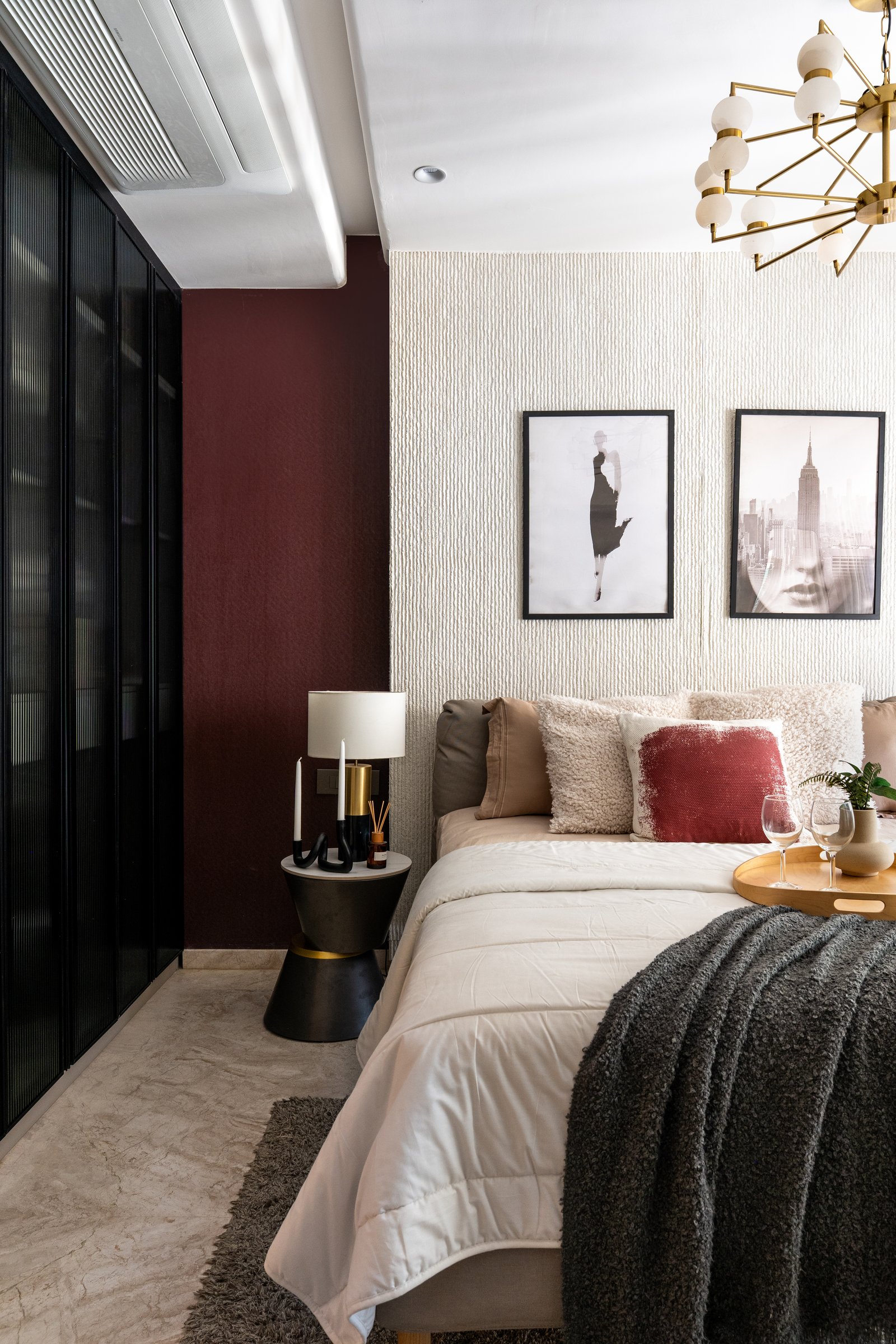 The wider view, where matte-black accents and rust-toned cushions soften the palette into something more inhabited