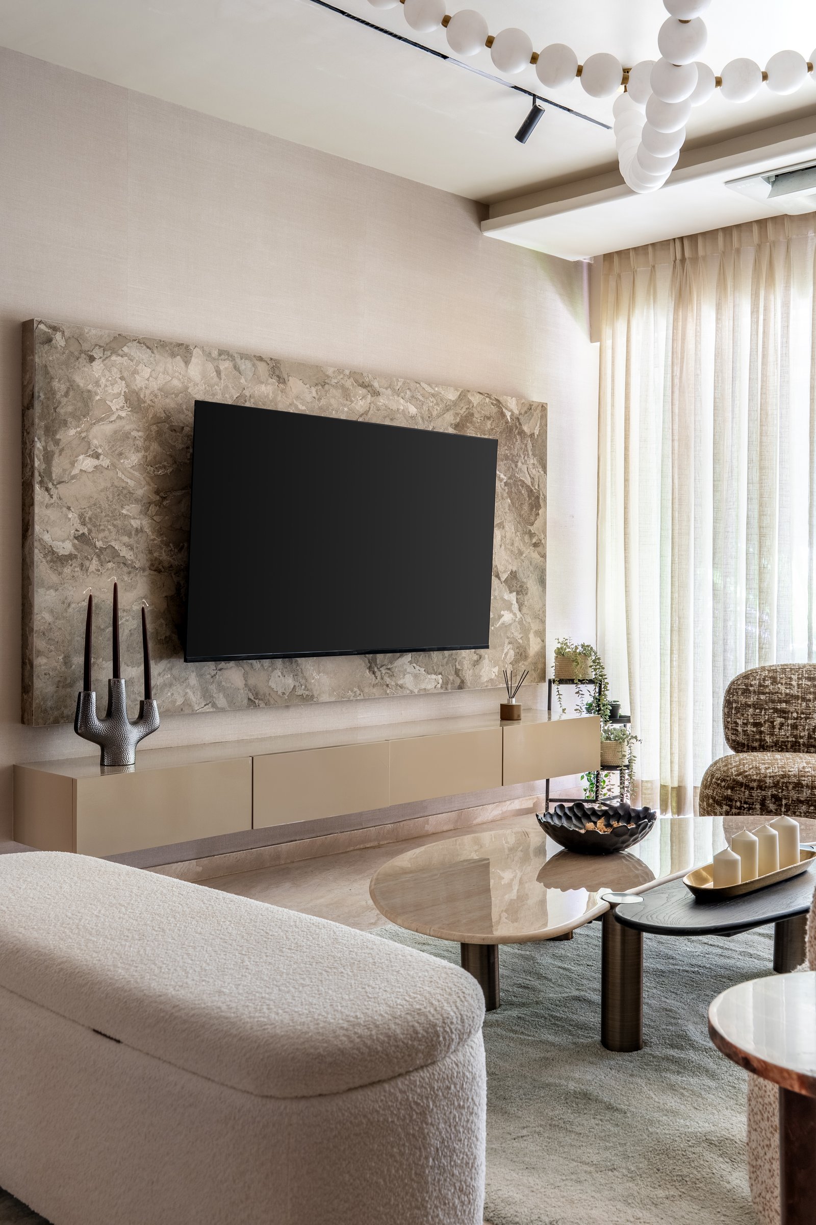 The media wall, where large-format veined stone gives the television a sense of place rather than dominance