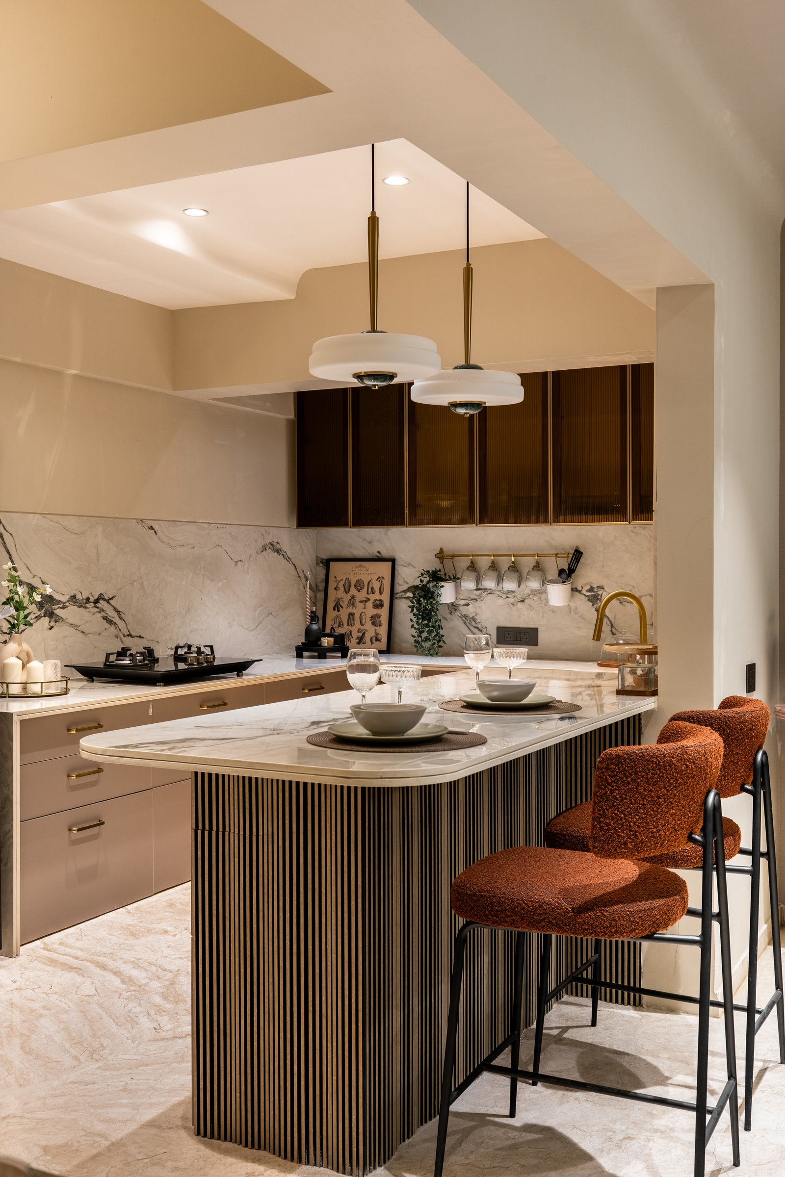 The kitchen, where reeded slats and bouclé bar stools in burnt sienna sharpen a neutral palette into confidence