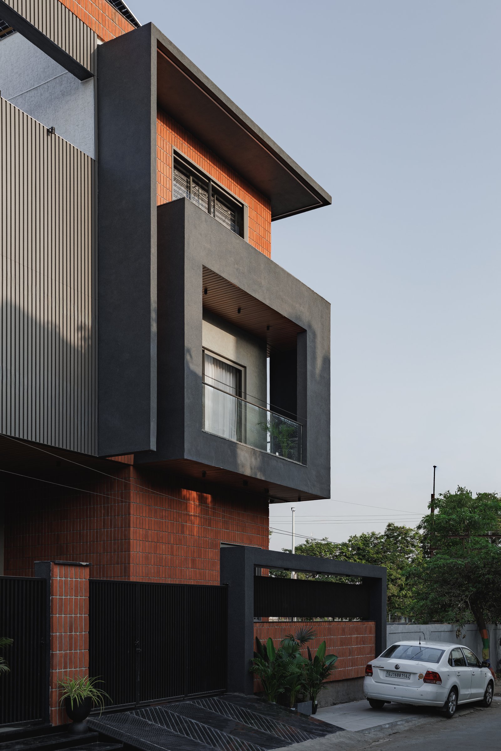 The side view, where the cantilevered concrete volumes recess the windows and control the west-facing heat gain