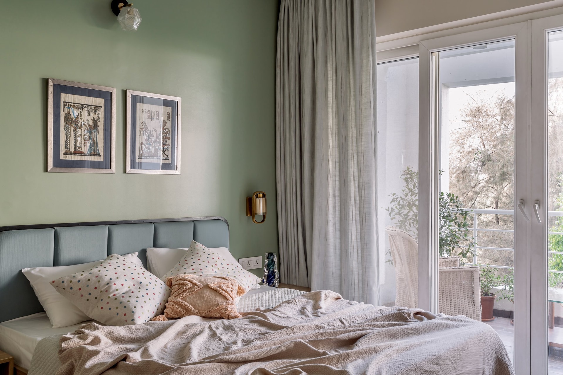 A wider view of the second bedroom, opening to a small balcony framed by French doors