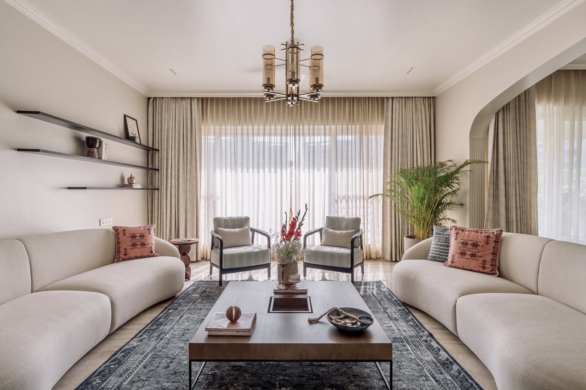 The principal seating arrangement, where a pair of curved sofas frames an unhurried conversation zone
