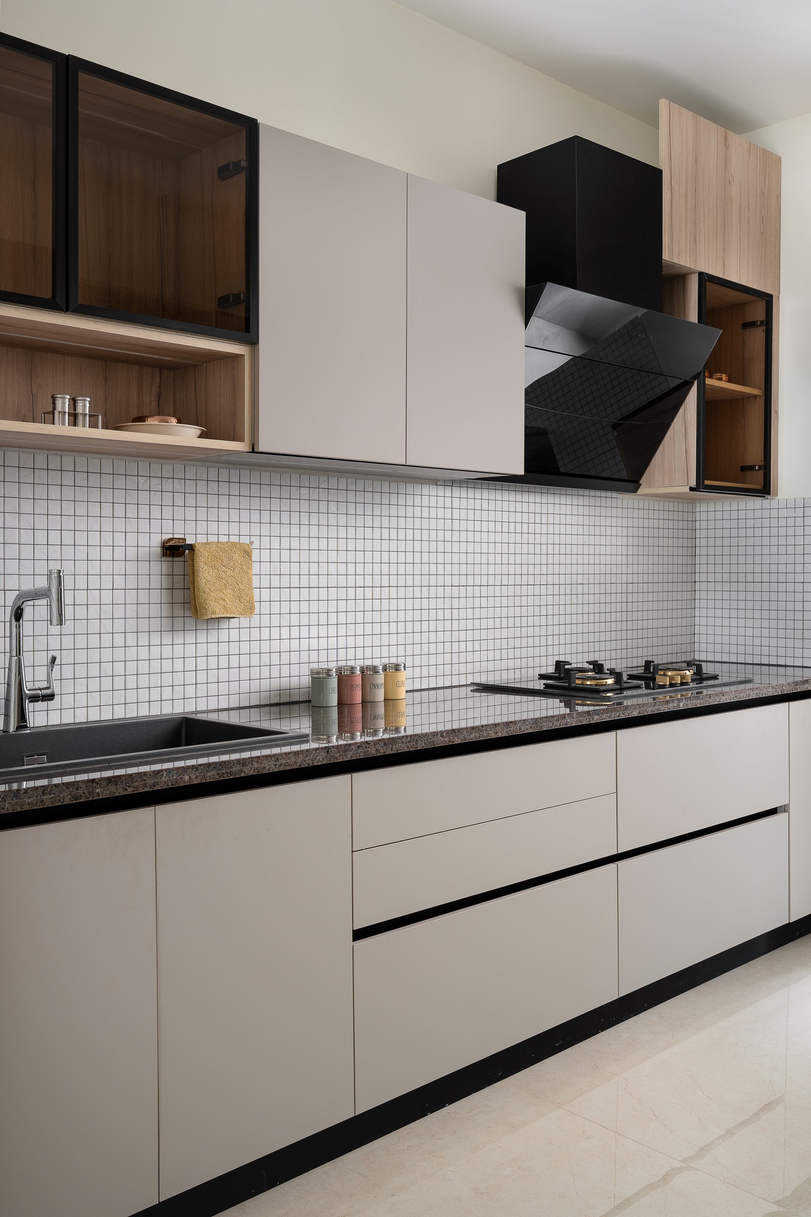 Closer in: a black glossy chimney, the kitchen's only permitted interruption to the matte field