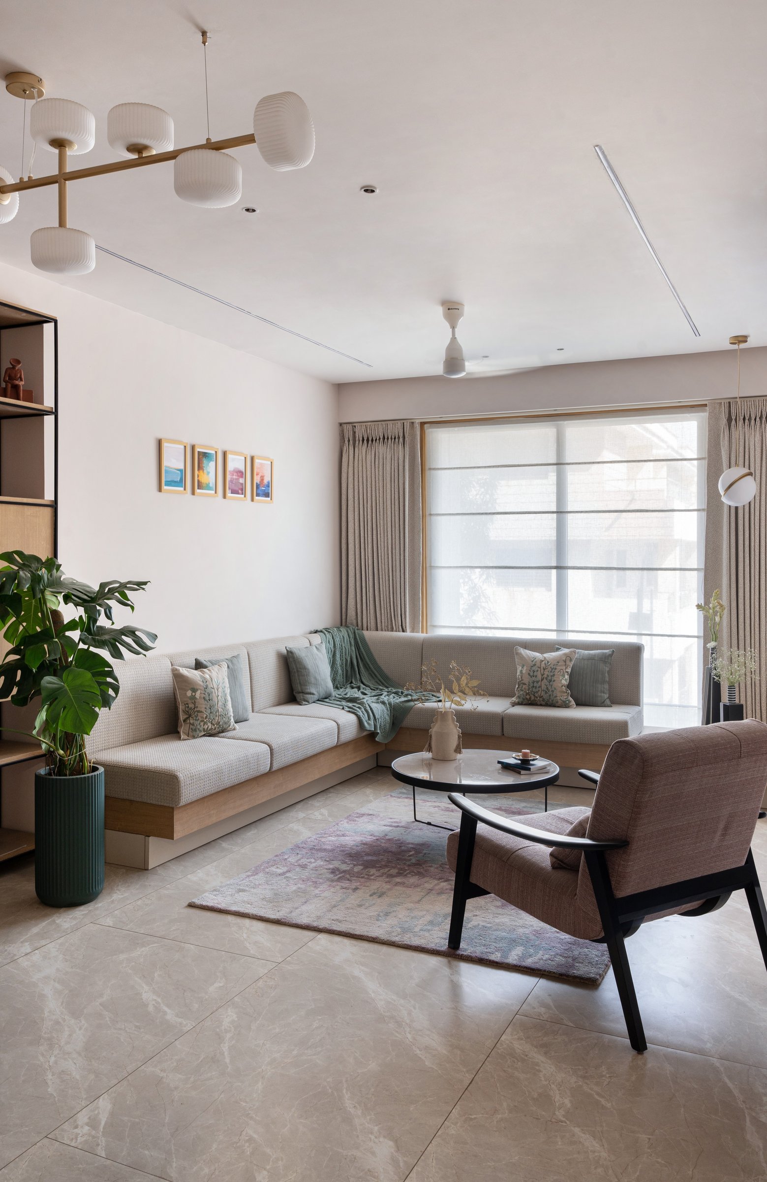 A wider view of the living room, with a linear pendant drawing the eye along the length of the plan