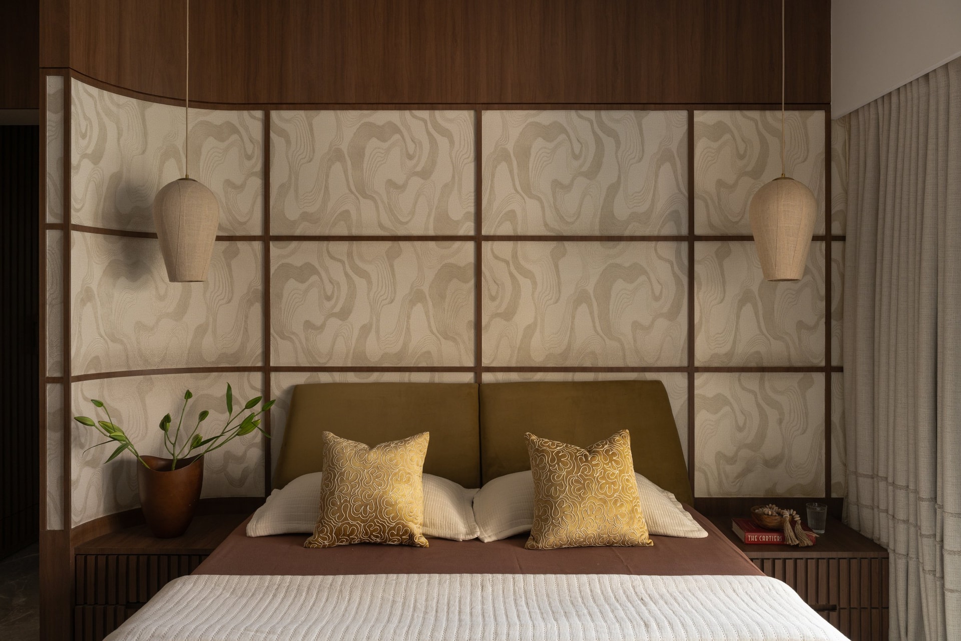 A closer view of the canopy-like wood header and the bedside jute pendant
