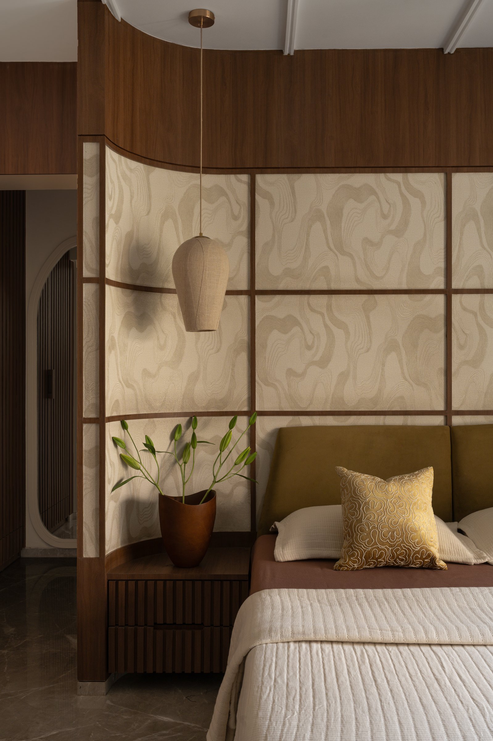 The third bedroom, where pale stone panels framed in walnut nod to shoji without imitating it