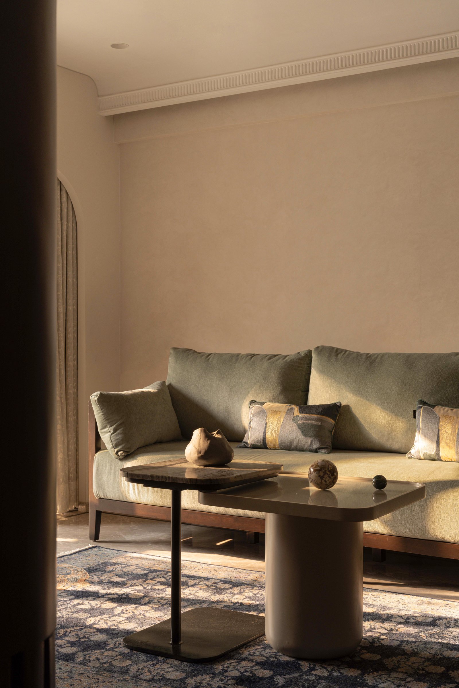 The fluted wood partition that holds the television and conceals the passage to the kitchen