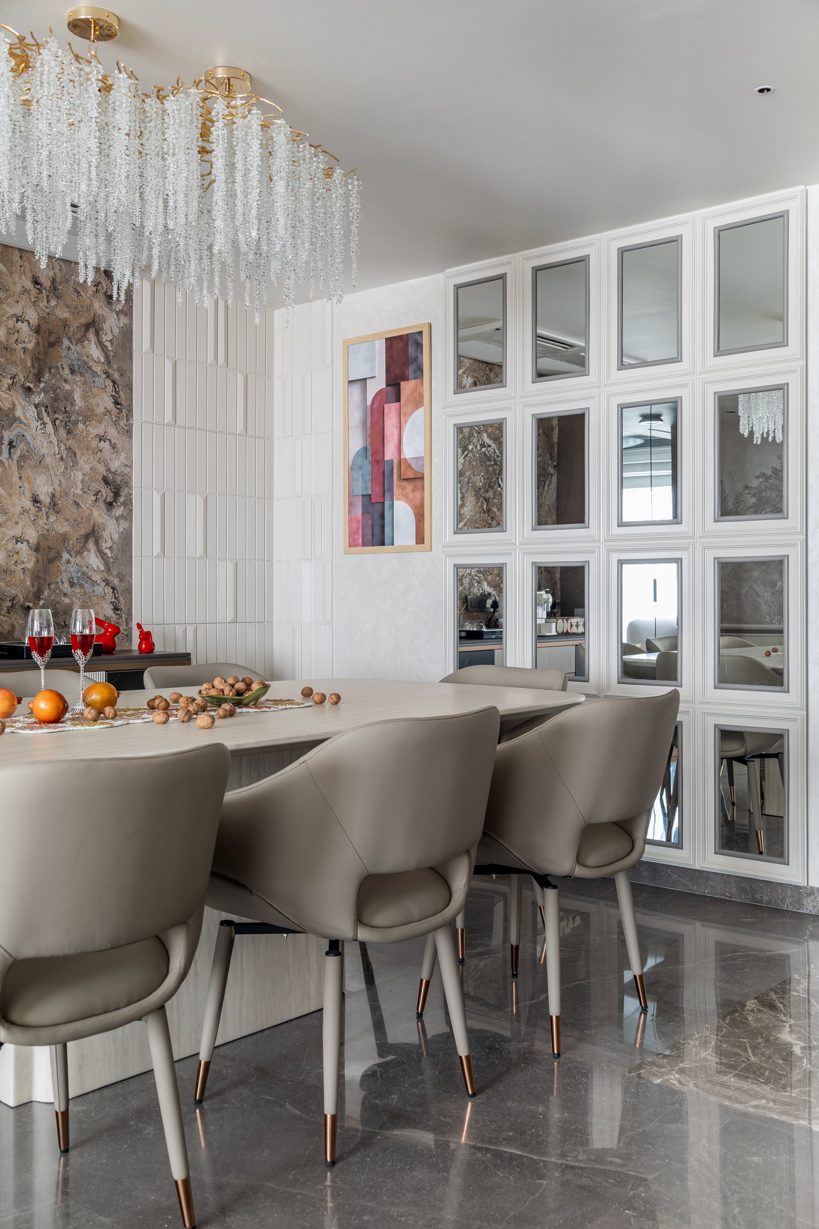 The dining backdrop, where veined stone, vertical tile, and a mirrored grid hold a single composed surface