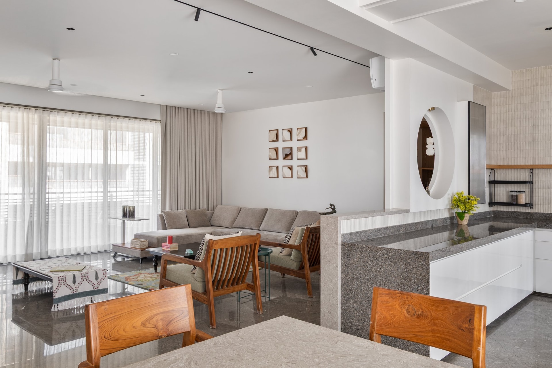 From the dining side, the living, kitchen, and dining zones share one luminous volume