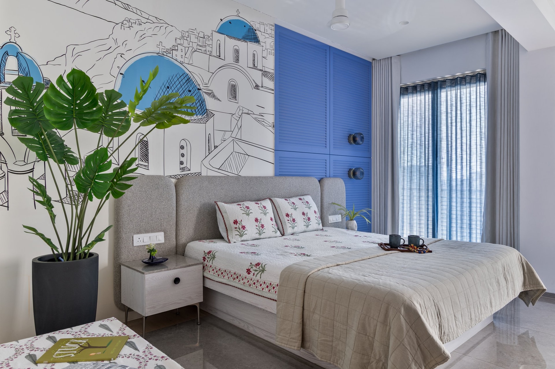 The second bedroom, a hand drawn coastal mural meeting a saturated louvered wardrobe