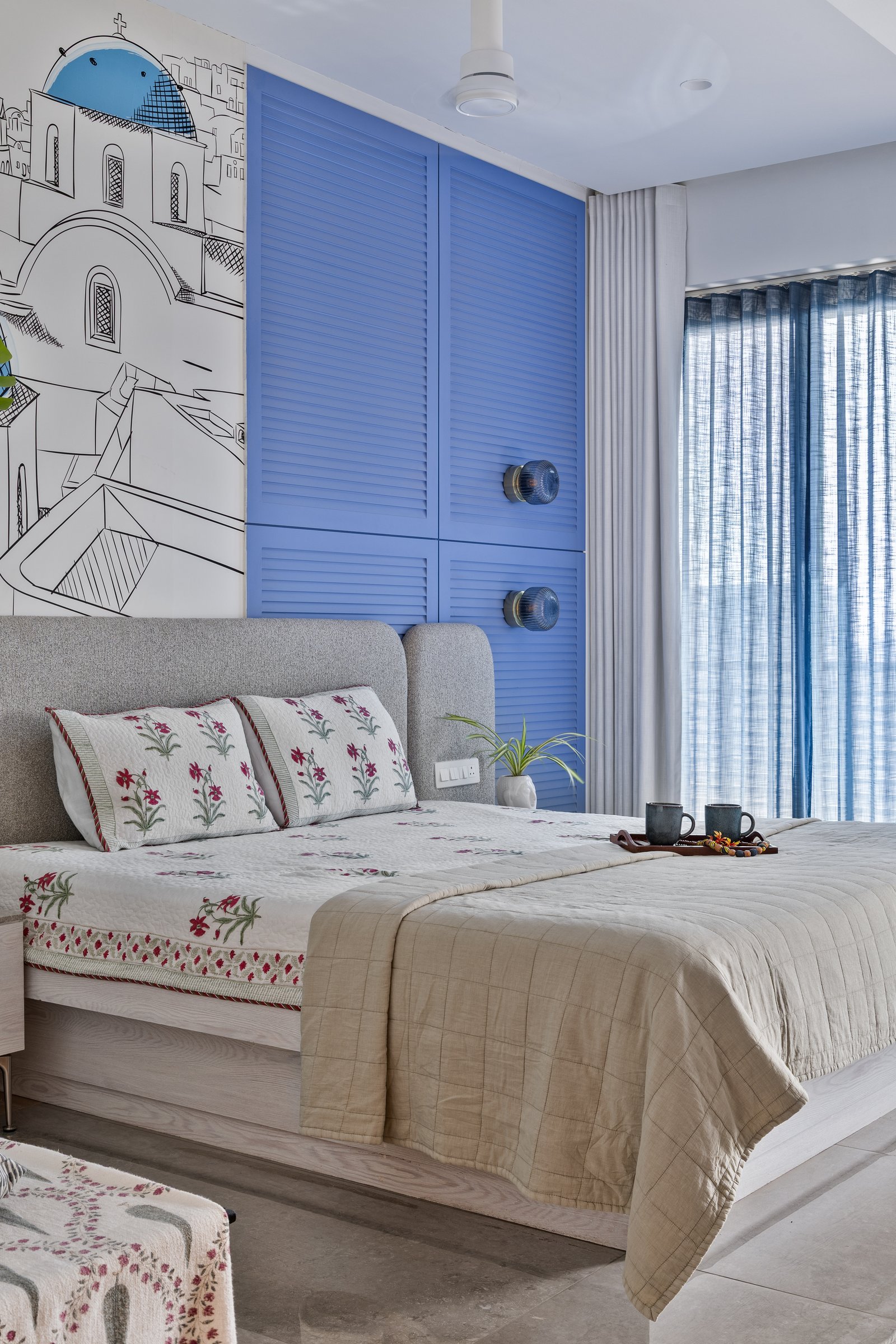 A closer view of the louvered cabinetry and mural, where exuberance is held within a steady architectural language