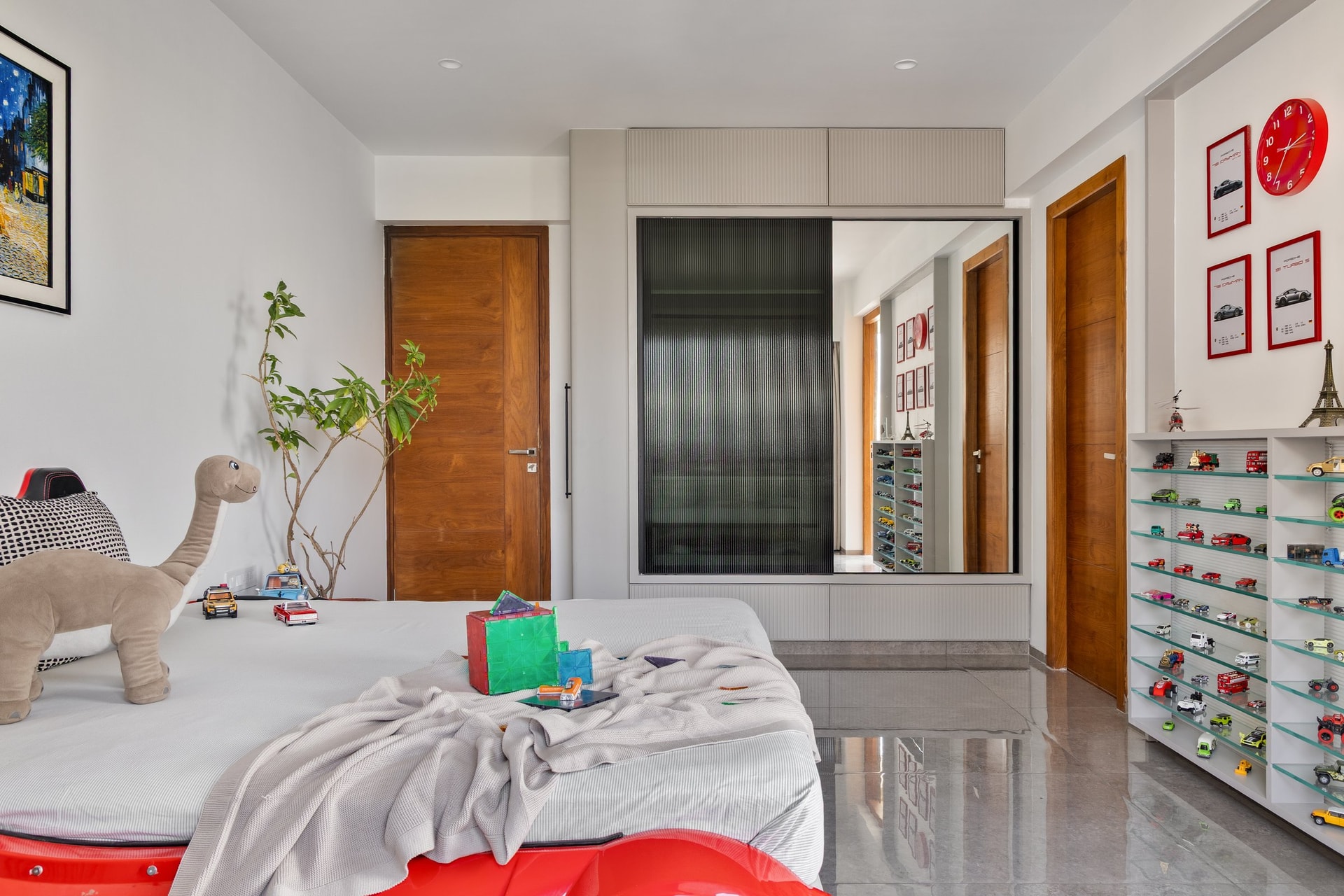 The children's room, its architectural shell kept neutral so that a collection of model cars can lead